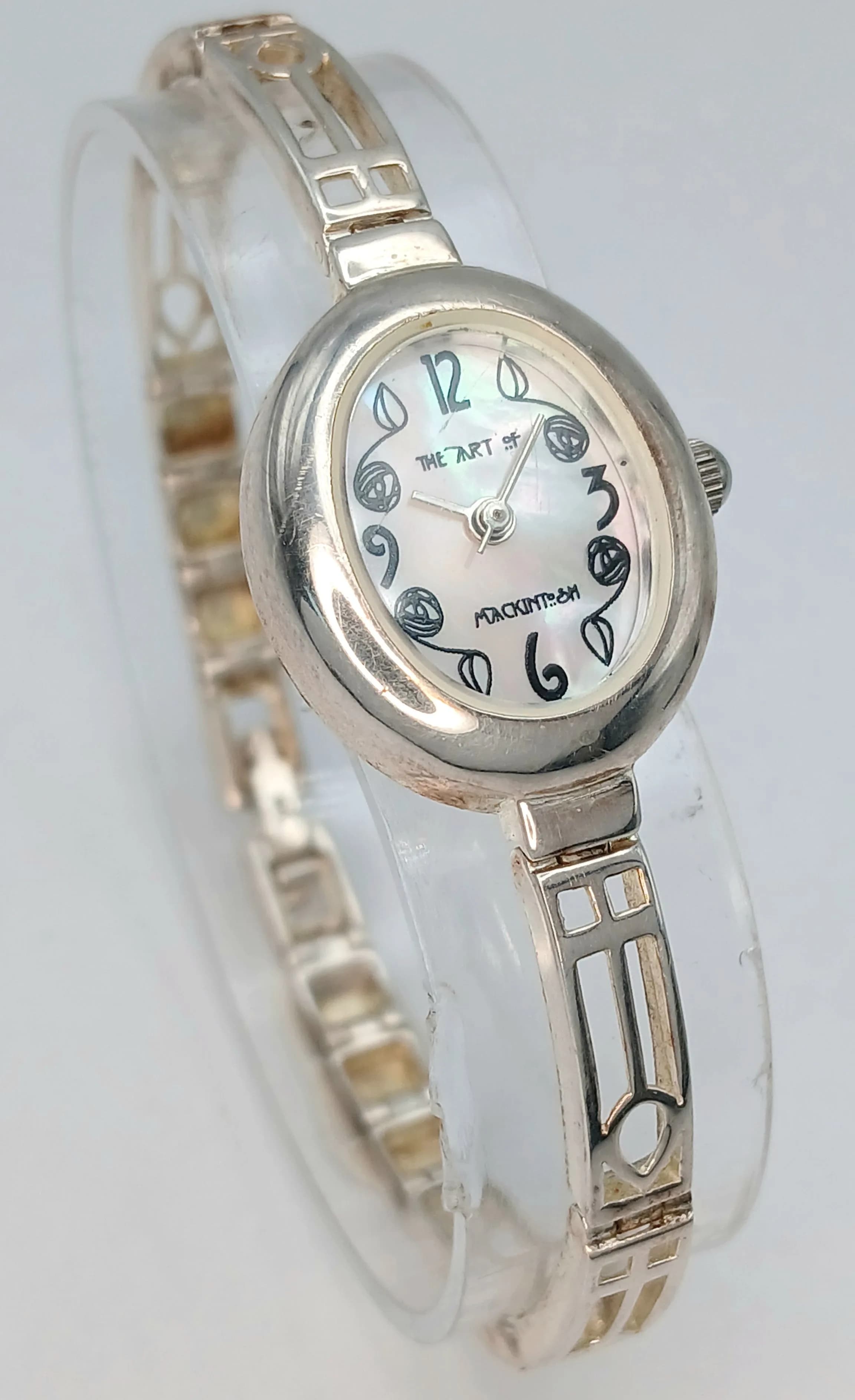 A 925 Silver The Art of Mackintosh Bracelet Watch. A decorative silver bracelet strap with a mother of pearl dial. 23.06g total weight.