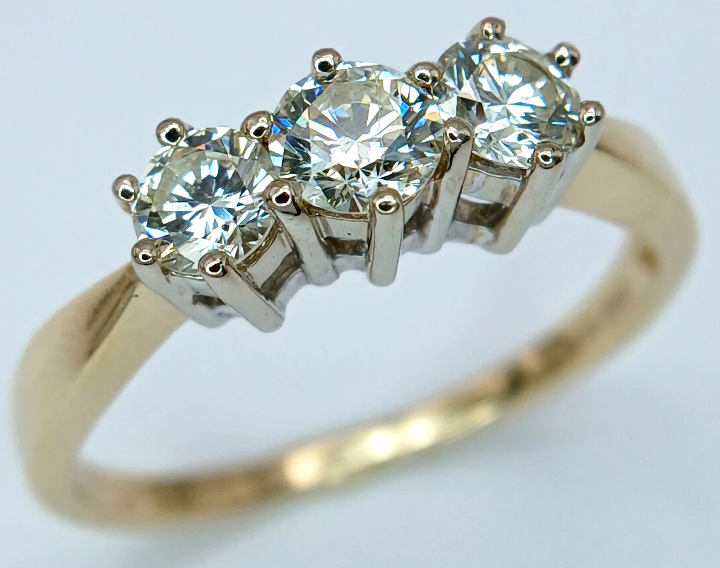 AN 18K YELLOW GOLD, DIAMOND, TRILOGY RING. 0.85CTW. 3G, SIZE N. SC 6063