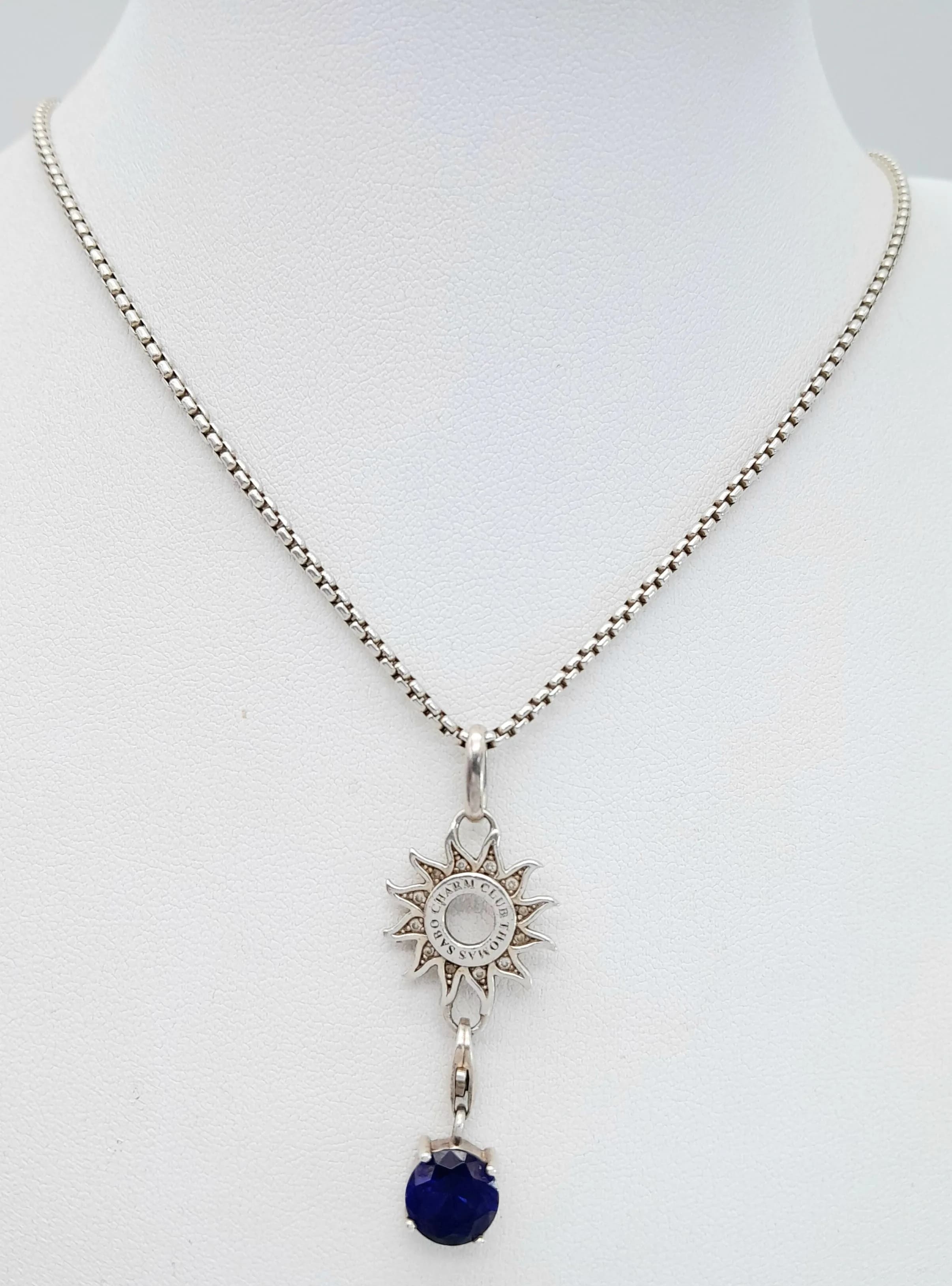 A THOMAS SABO, STERLING SILVER, 21" NECKLACE WITH SUN CHARM CARRIER AND BLUE STONE CHARM. 13.3G. A/S SIL 5001
