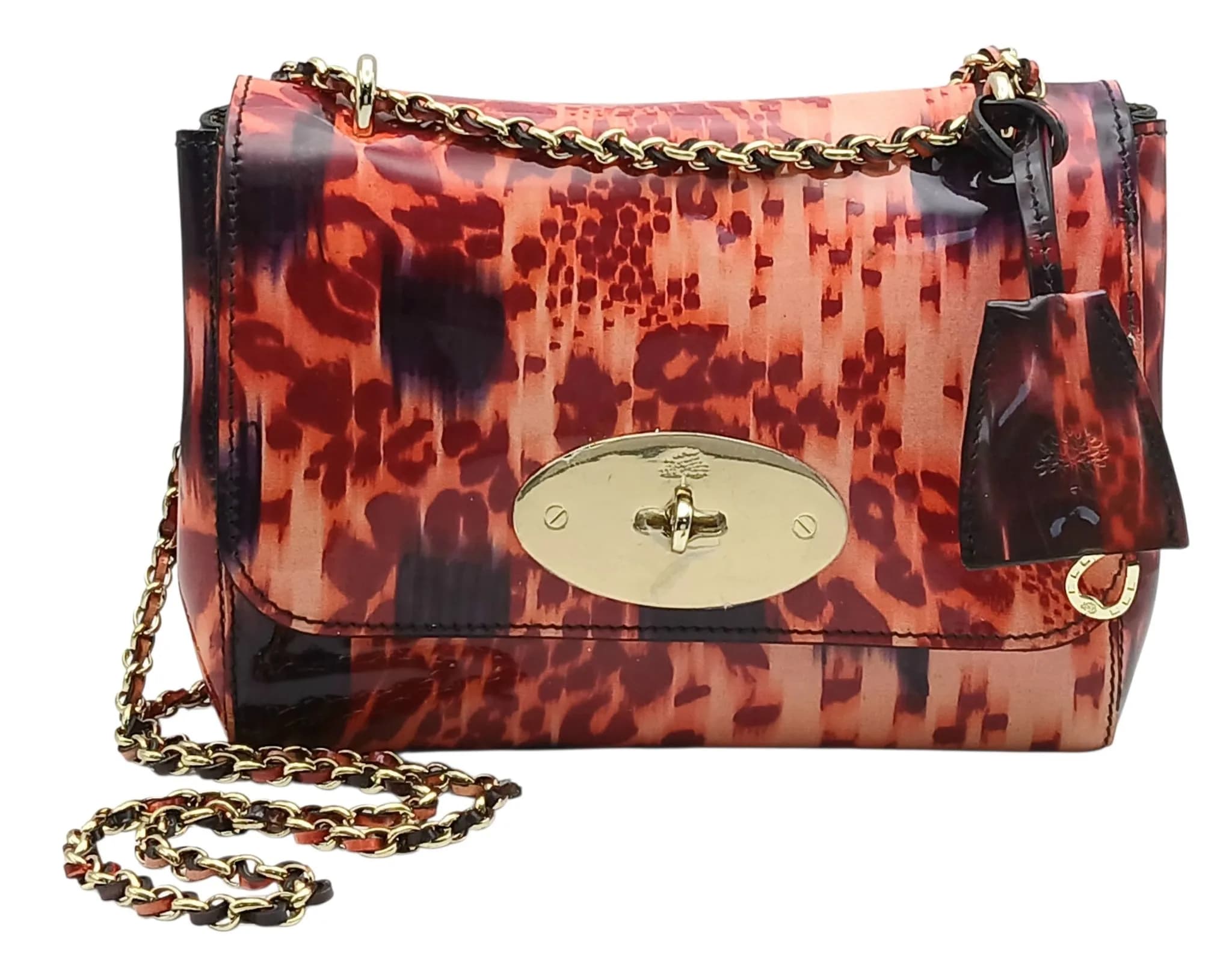 A Mulberry Loopy Leopard Lily Shoulder Bag. Leopard print patent leather exterior with gold-toned hardware, chain and patent leather strap, clochette and twist lock closure. Grey/Brown textile interior with a zipped side pocket. Approximately 22cm length x 16cm height. Some light scuffs to exterior, an 8mm x 4mm patch of peeling gloss, some small speckled stains to interior - please see photos for conditions or request a condition report. Ref: 29081