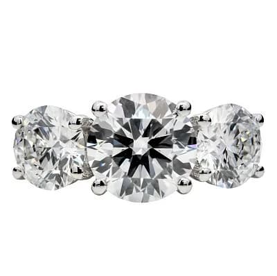 A PLATINUM ROUND CUT LAB GROWN DIAMOND 3 STONE RING. CENTRAL STONE 2.03CT, SIDE STONES 2.00CTW. COLOUR D, CLARITY VS2. IGI CERTIFIED. CERT NO: LG768673188, LG778635382, LG778641631. TOTAL DIAMOND WEIGHT: 4.03CTW. TOTAL WEIGHT 6.74g. SIZE K 1/2. Ref U4541