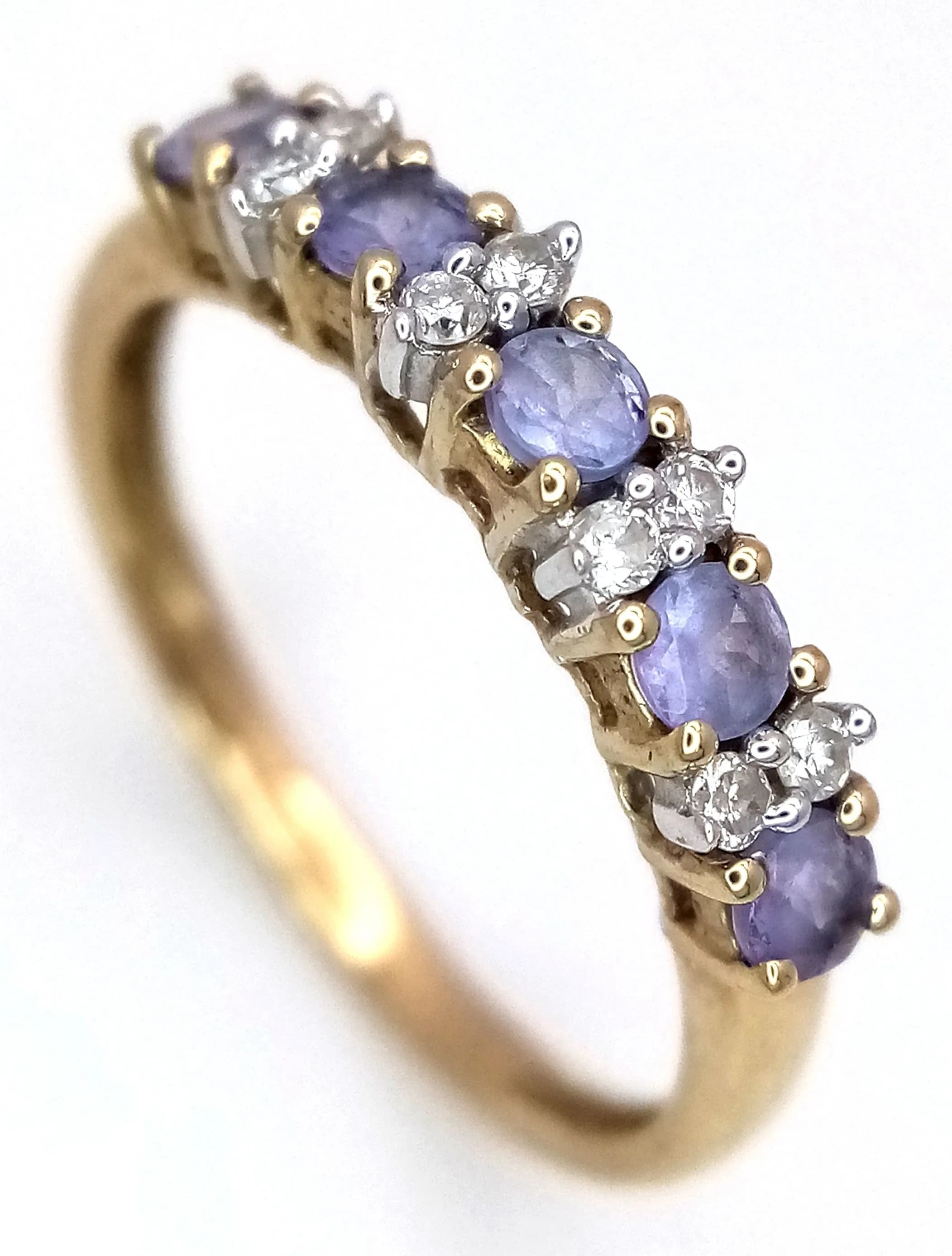 A 9K YELLOW GOLD, DIAMOND AND IOLITE RING. 1.5G, SIZE N. TAN 6003