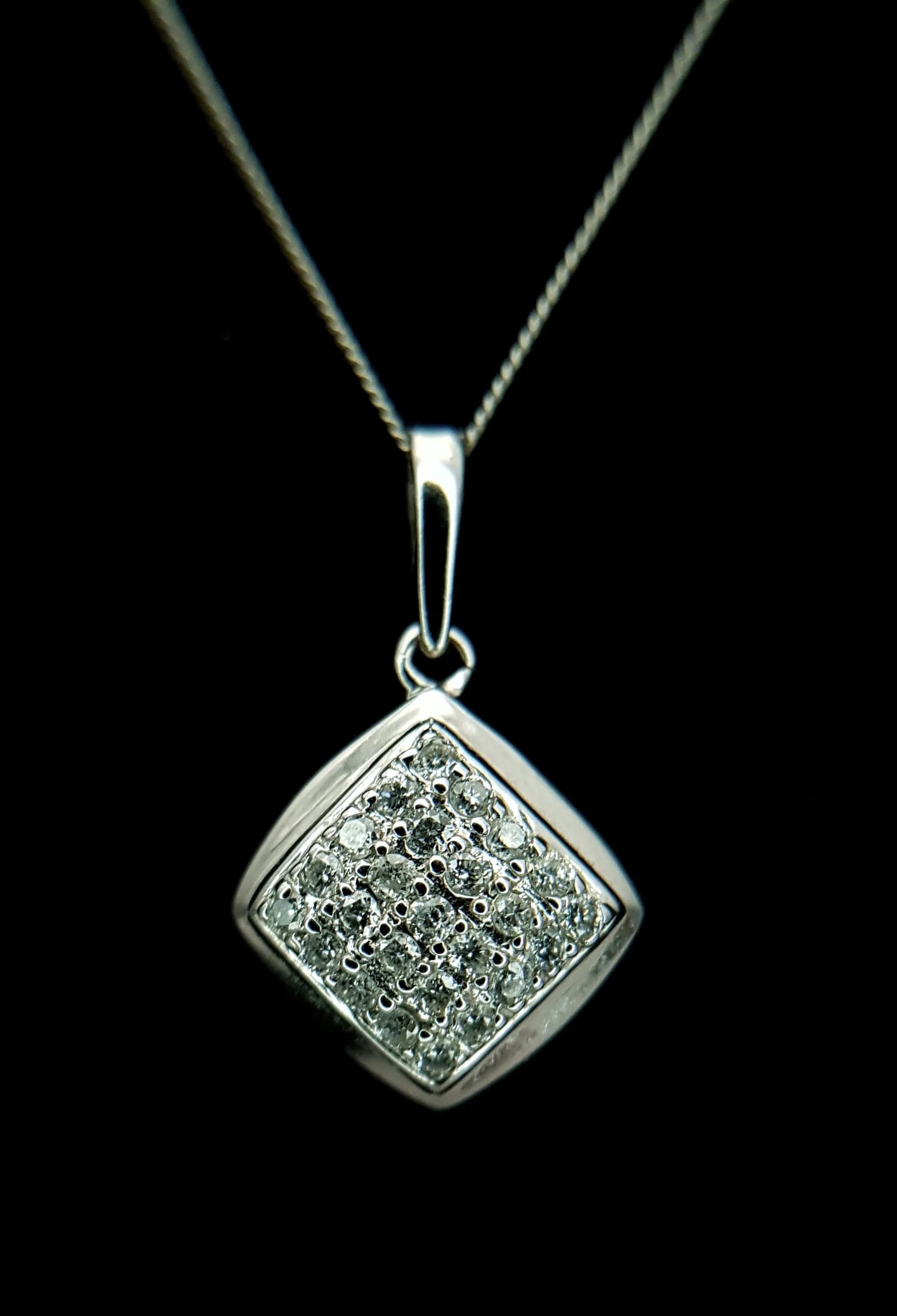 A 9K White Gold Cluster Pendant on a 9K White Gold Disappearing Necklace. 0.25ctw. 2cm pendant. 42cm necklace. 2.1g total weight. 028829.