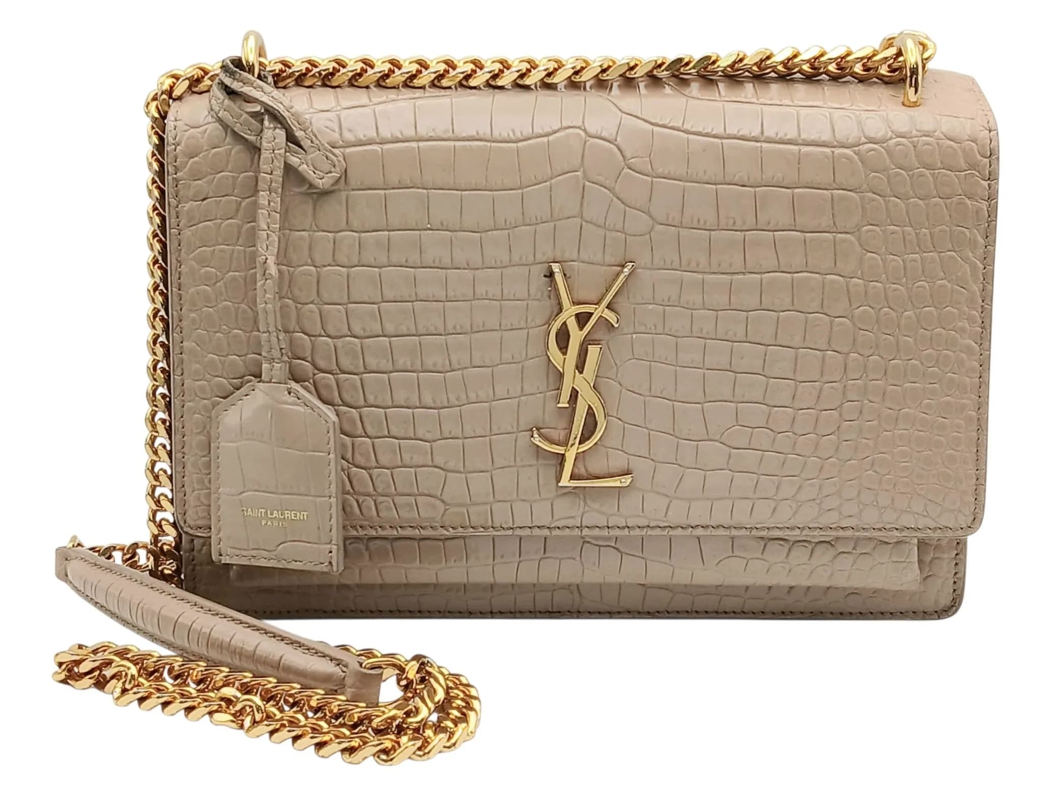 A Saint Laurent Beige Sunset Shoulder Bag. Croc-embossed leather with gold-turned hardware, chain and leather strap, detachable clochette and magnetic closure. Beige textile accordion style interior with two main compartments, open compartment to front and an open inner side pocket. RFID tagged. Comes with dust cover and authenticity card, RFID booklet and care booklet. Approximately 22cm length x 15cm height. Signs of wear to corners, some small stains to interior - please see photos or request a condition report. Ref: 29070