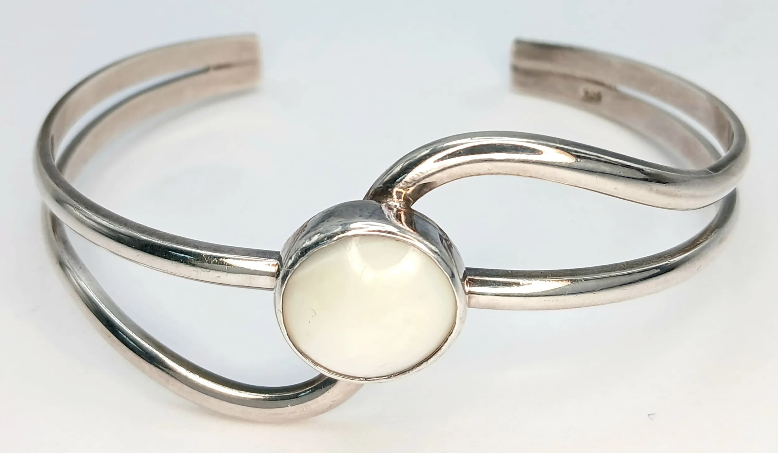 A 925 Silver Mother of Pearl Cuff Bangle. 20.68g total weight.