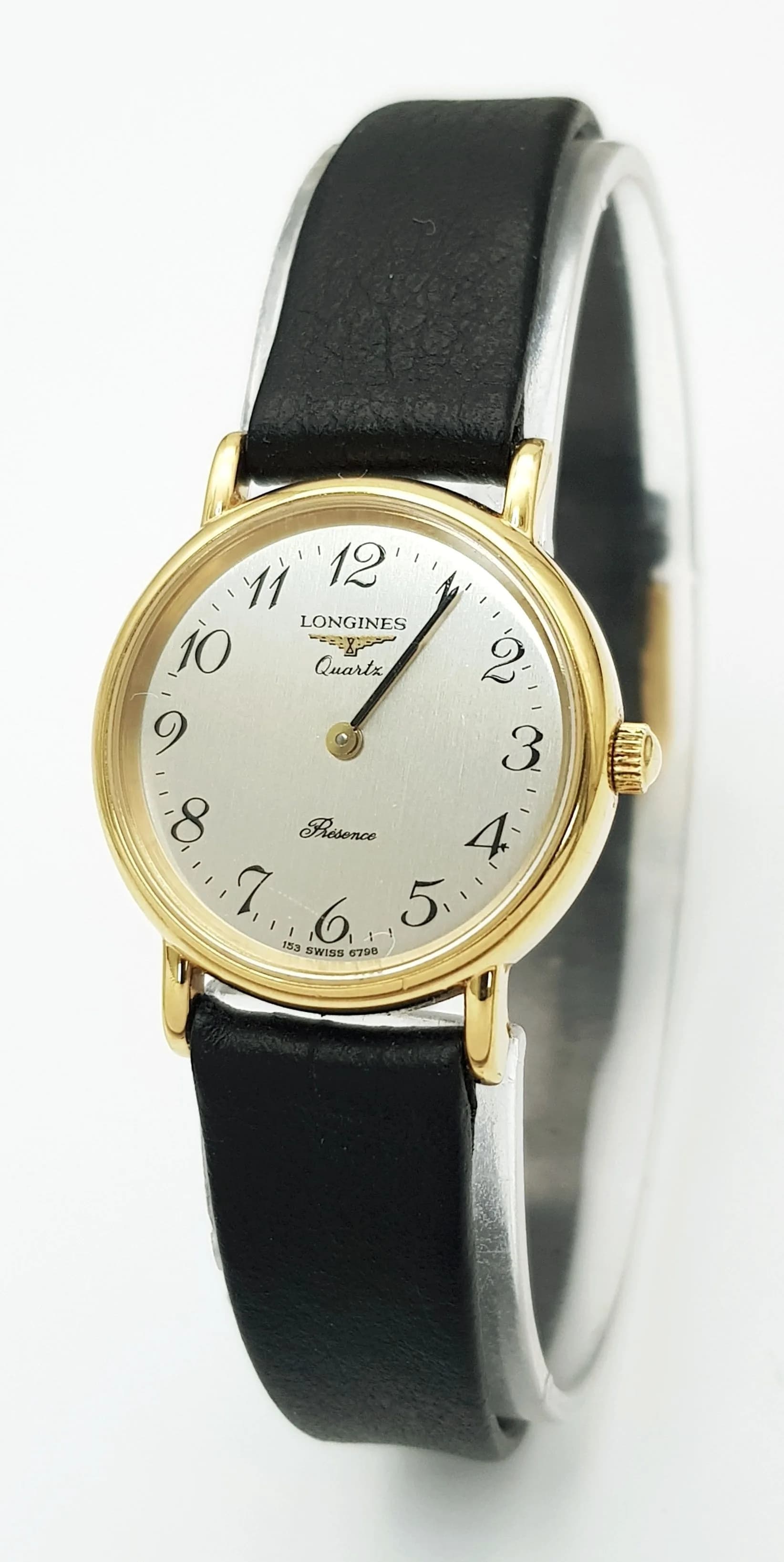 A Vintage Longines Prescence Ladies Watch. Quartz movement. Black leather strap. Gilded case - 24mm. In working order. Comes with case. Ref: 28994