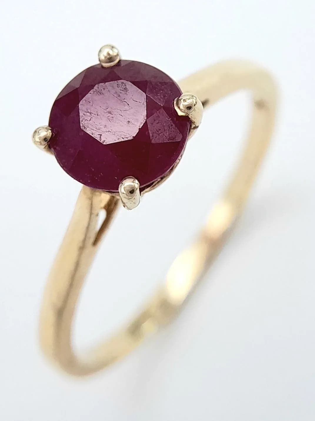A Stylish Gold Gilded Sterling Silver Ruby Solitaire Ring Size S. The Ring is set with a 7mm Round Cut Ruby approximately 1.5 Carat. Gross Weight 2.21 Grams.