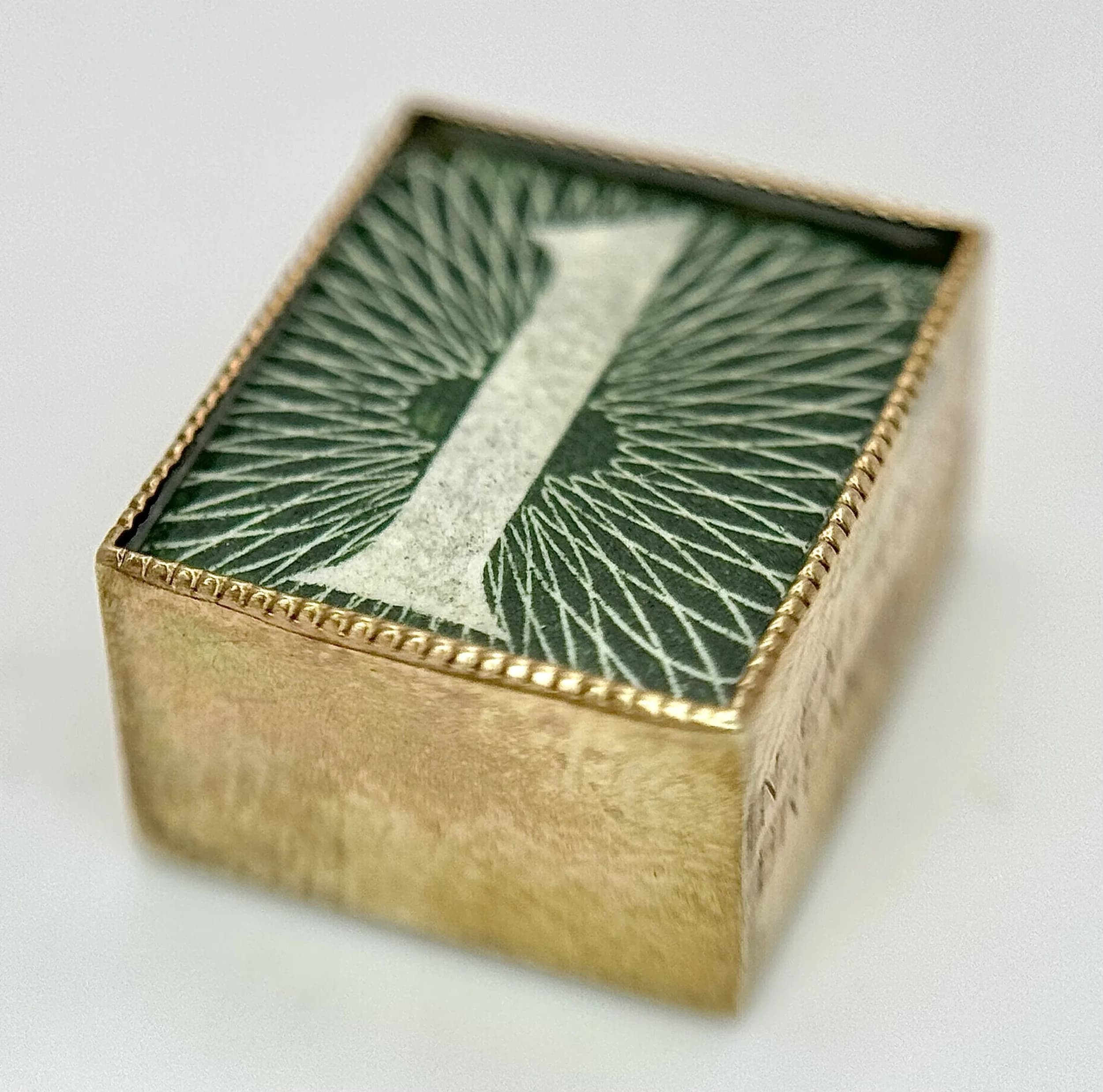A Vintage 9K Yellow Gold, One Shilling Note Pendant/Charm.15mm. 2.4g total weight.