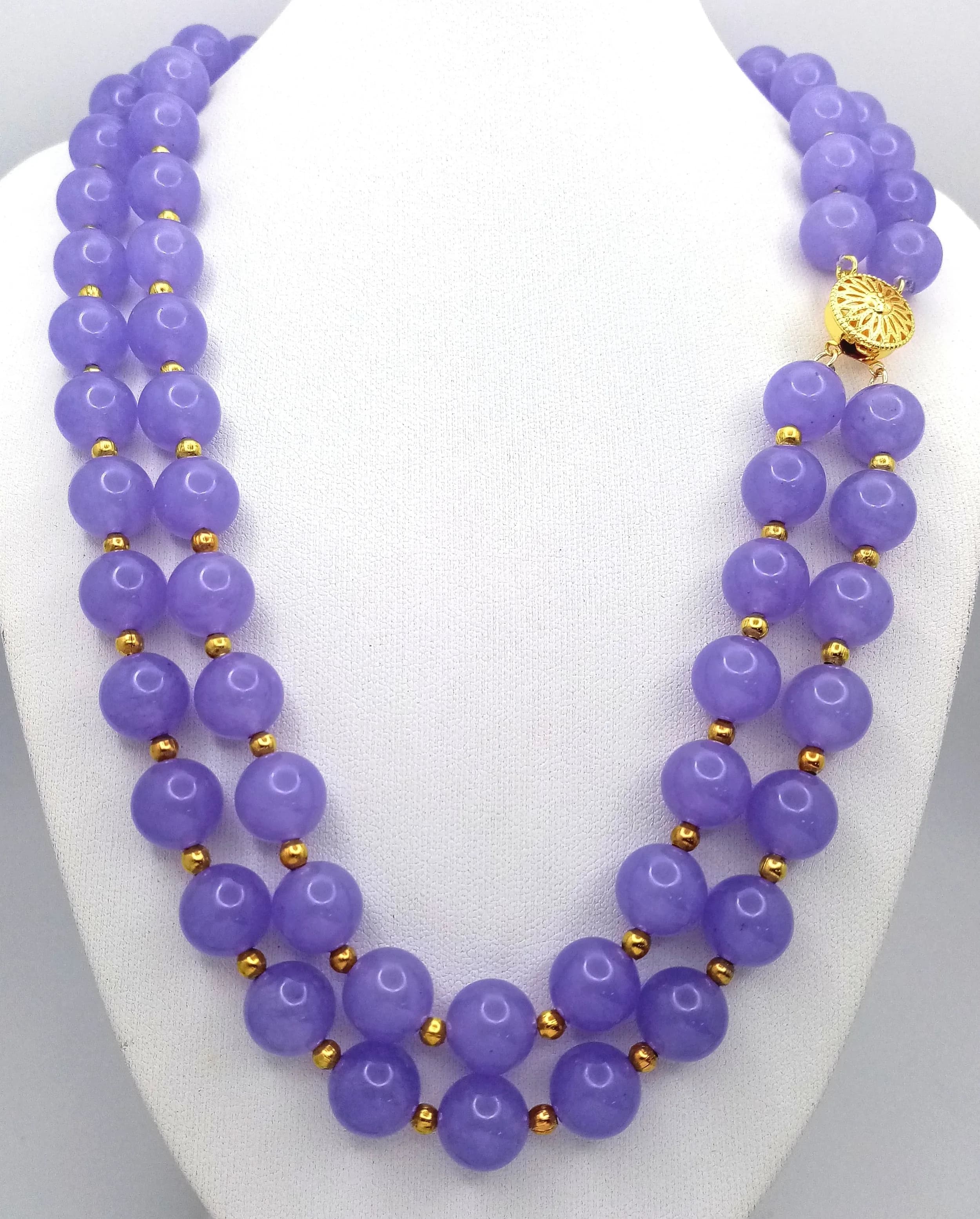 A Two Strand Lavender Jade Beaded Necklace. 10mm beads. 42-44cm. Gilded spacers and clasp.