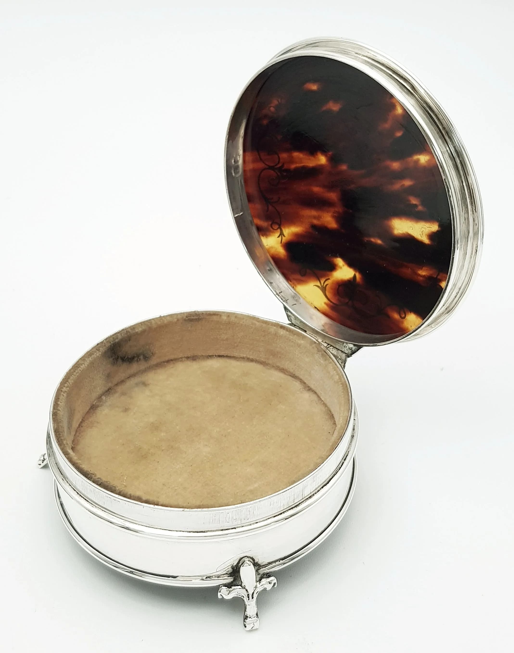 An Antique Mappin & Webb Sterling Silver and Tortoise Shell Trinket Box. Velvet lining. Hallmarks for Birmingham, 1922 and maker's mark MN&WB. 8cm length x 3.5cm height. 154.86g total weight.