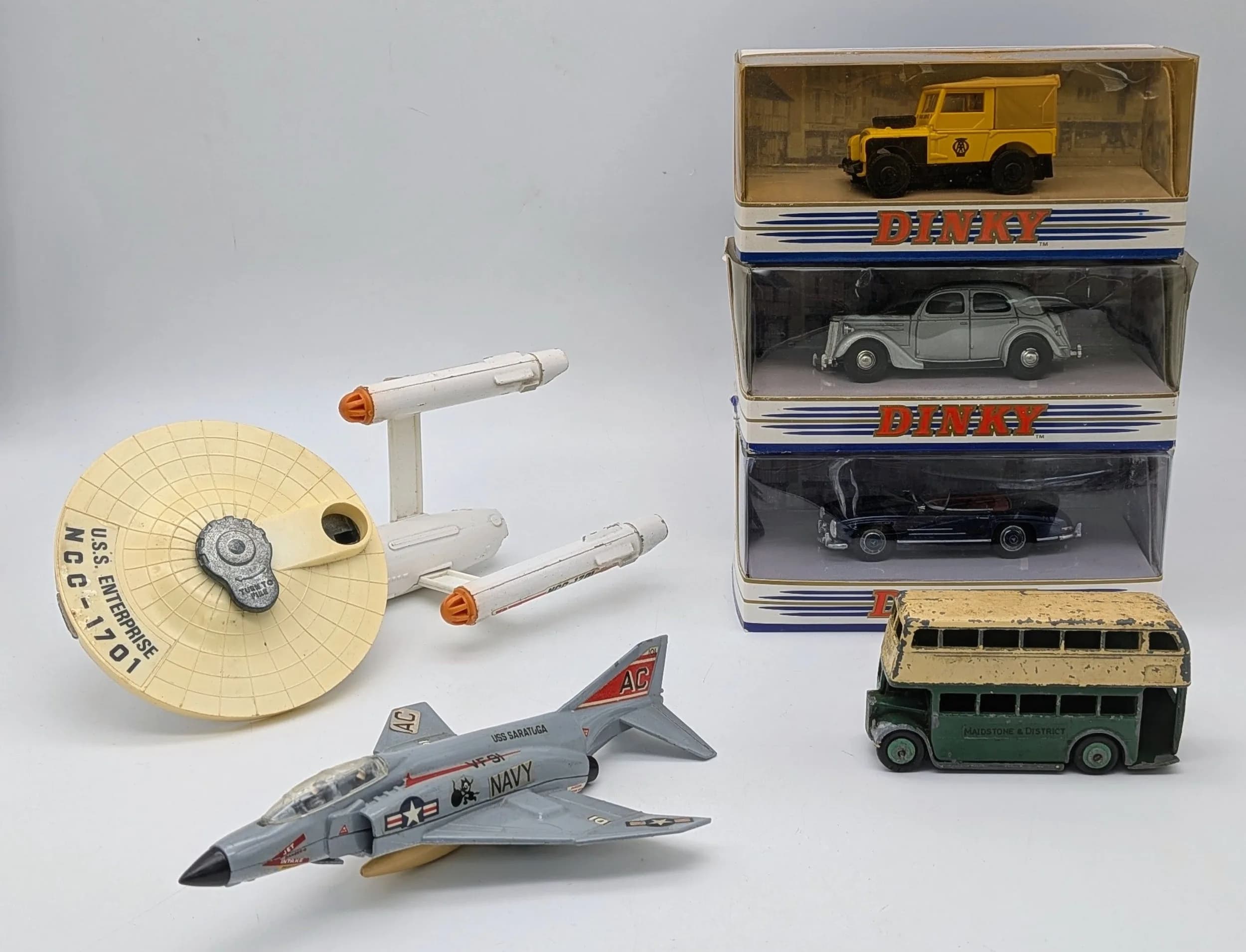 Six vintage Dinky toys. Three in boxes and three loose. Including the USS Enterprise.