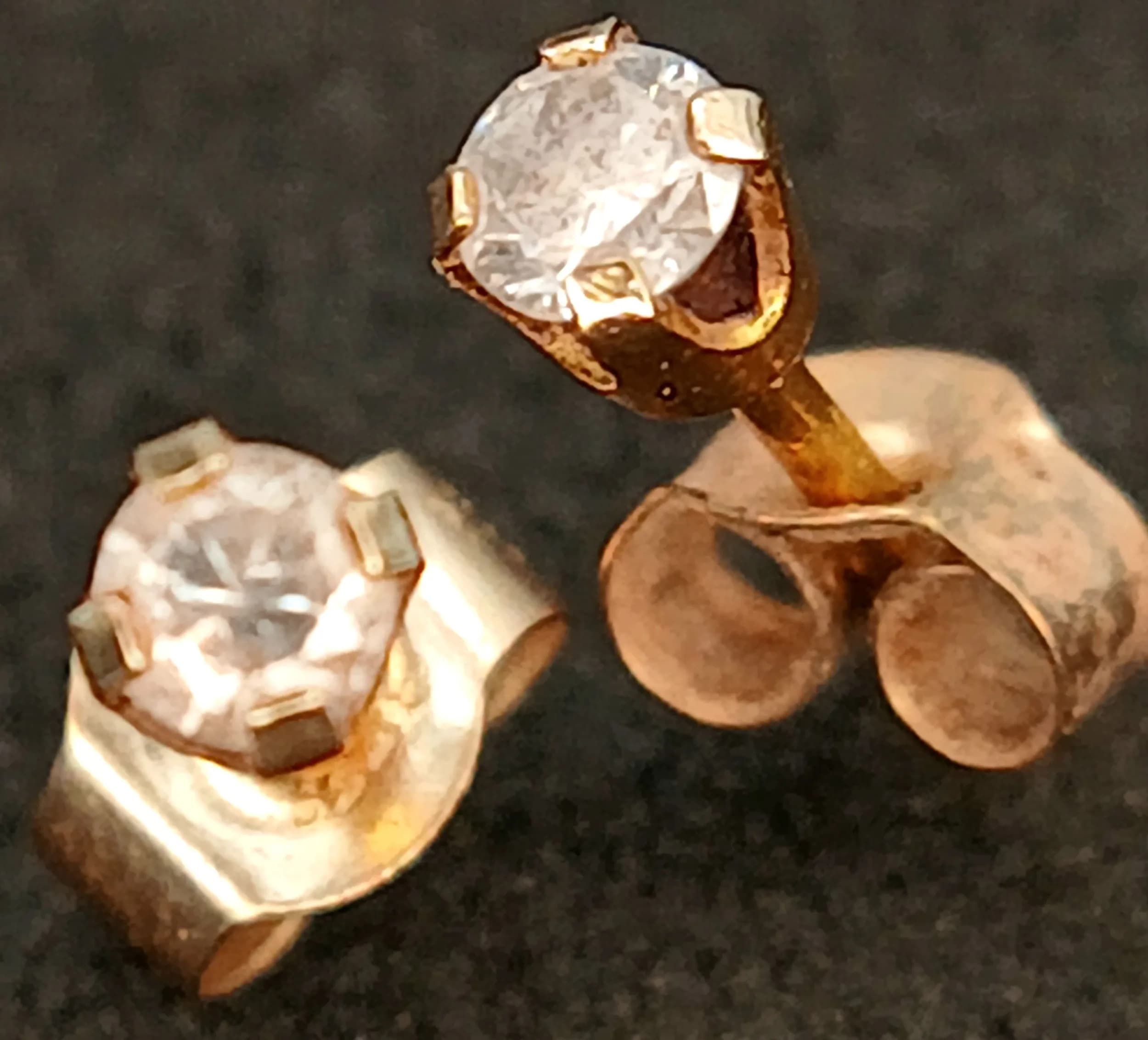 A Pair of Petit 9K Gold, Diamond Stud Earrings.