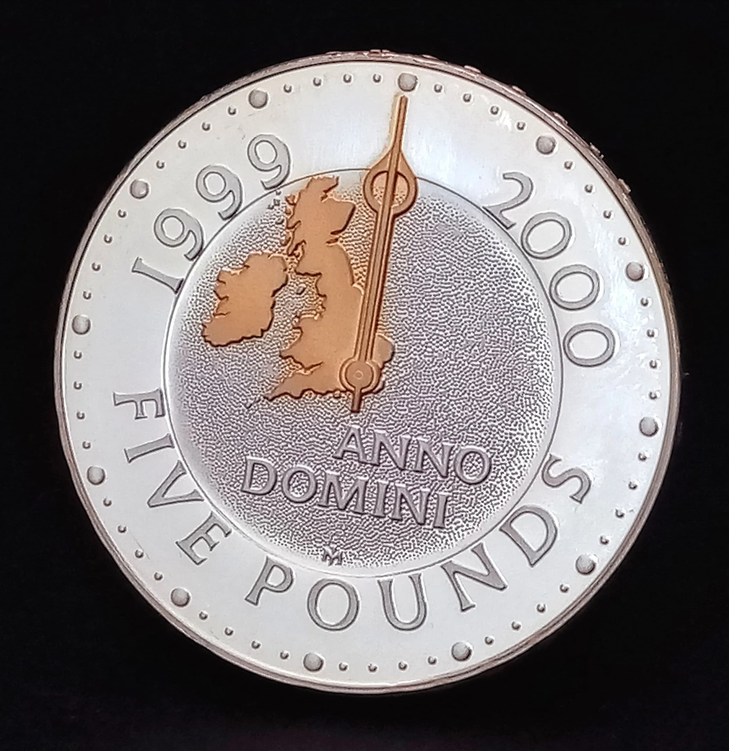 A £5 Millennium Commemorative Sterling Silver Proof Coin. Encapsulated with COA and case. 28.28g.