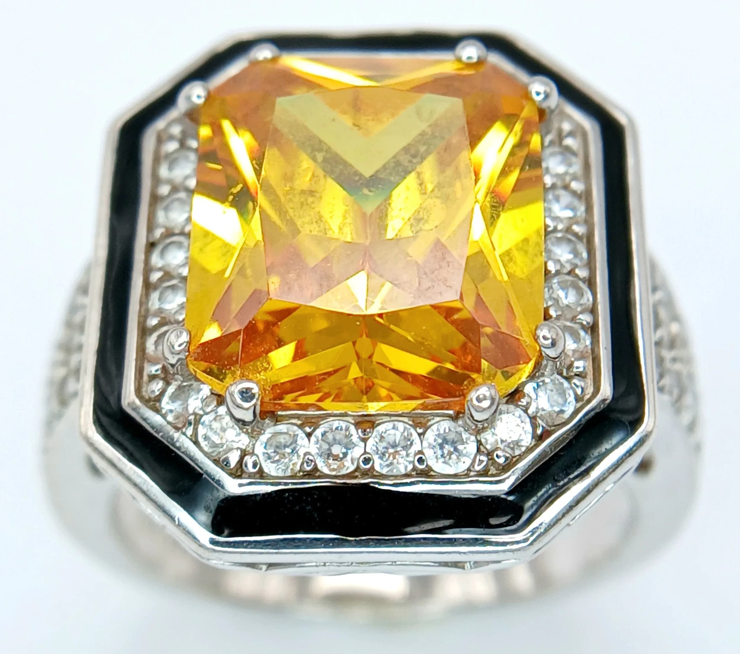 A Sterling Silver Yellow and White Stone Art Deco Design Ring Size M. The Crown measures 2 x 1.7cm and the ring has a gross weight of 7.59 grams.
