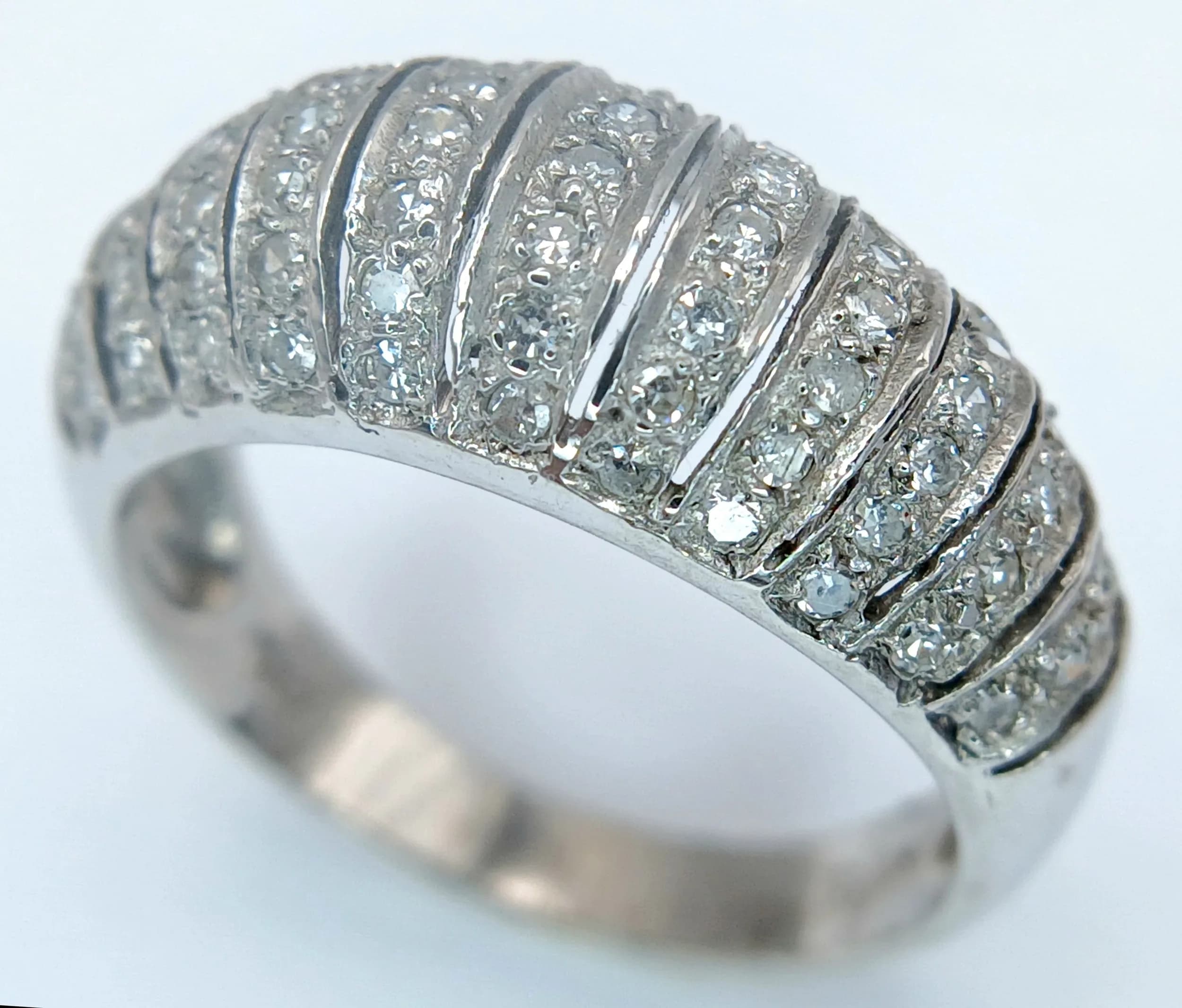 A 14K white gold domed diamond ring, 0.33ct diamond weight, 3.8g total weight, ring size M. Ref: SH6681H