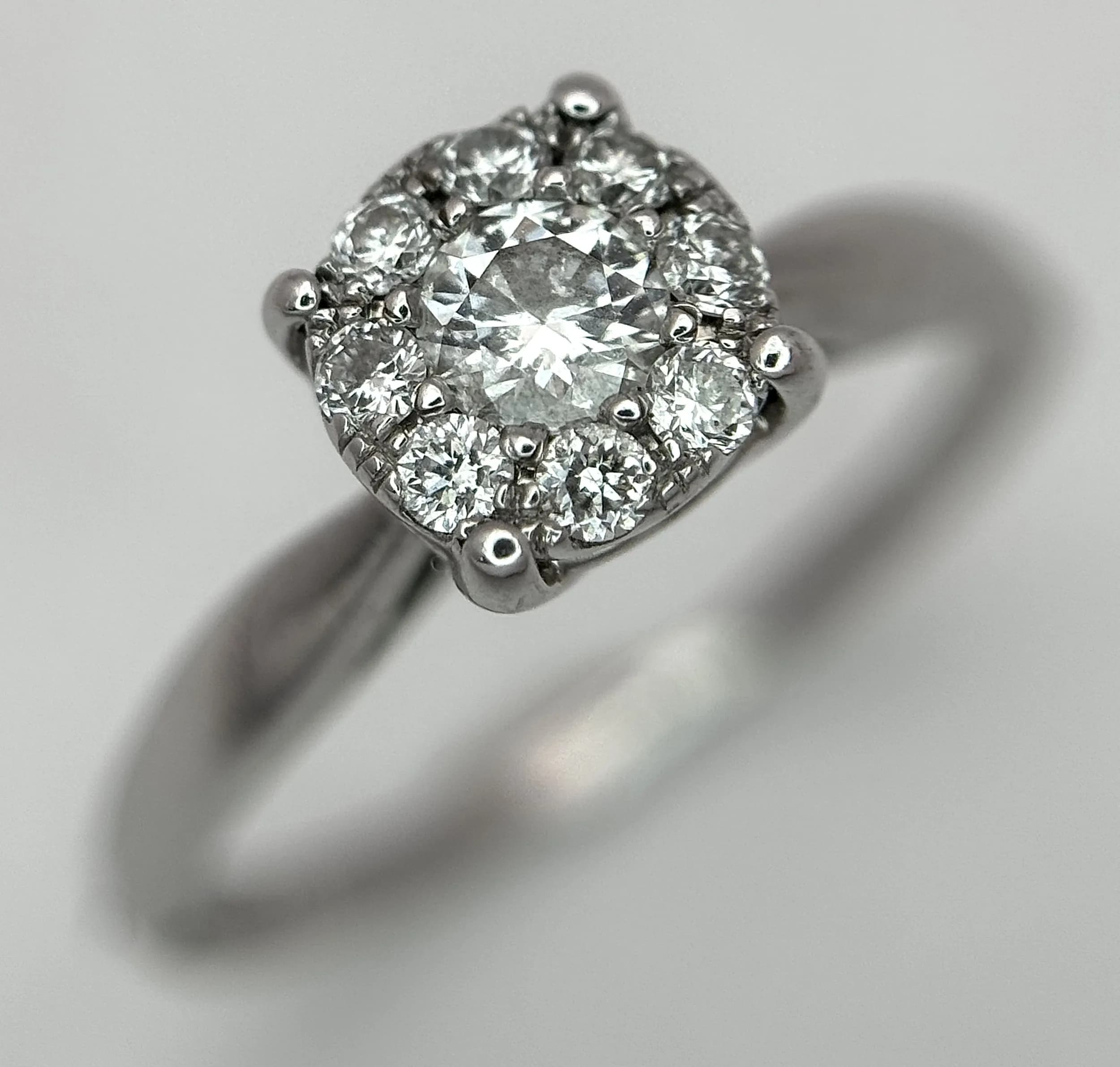 An 18K white gold diamond cluster ring, 0.23ct diamond weight, 2.7g total weight, ring size J. Ref: SH8517H