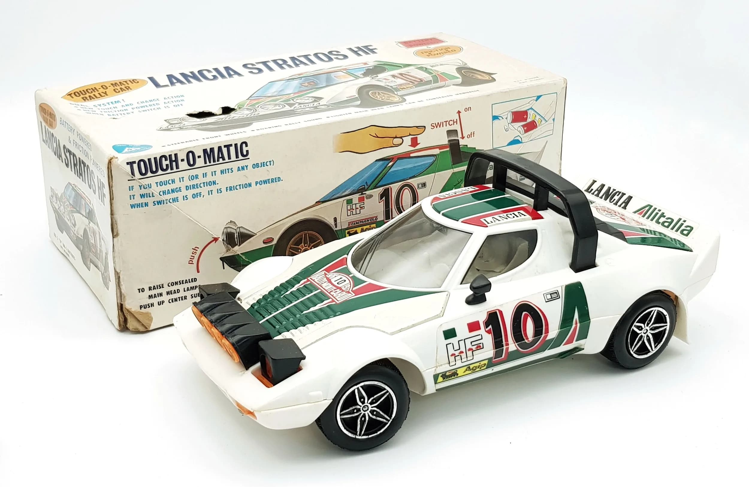 A vintage Alps touch o matic Lancia Stratos HF rally car. Battery and friction powered. Works perfectly. 1960's. Box has some wear from storage.
