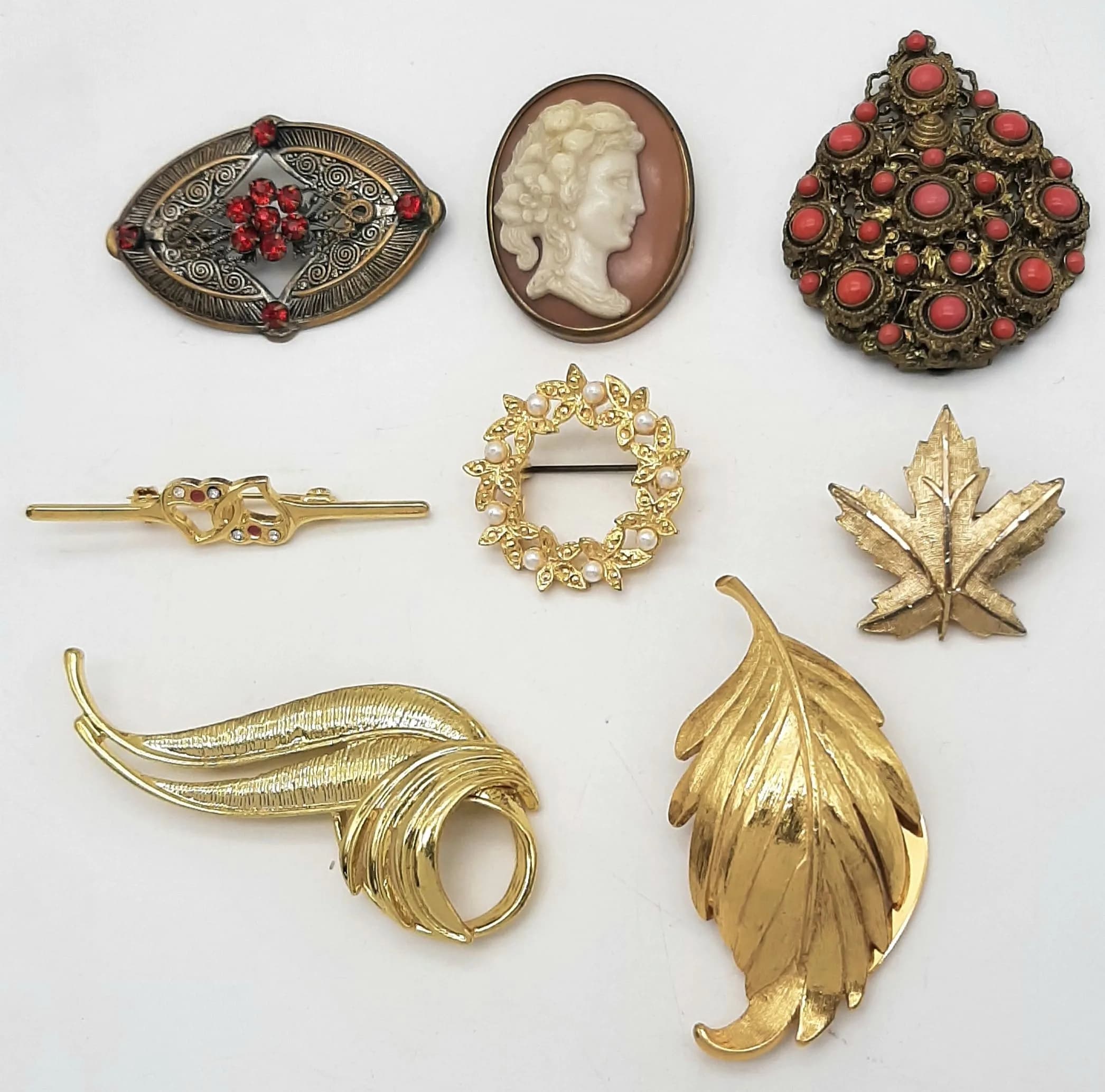 A Parcel of Eight Vintage Gold Tone Brooches and Clips. Cameo, Stone Set, Pearl etc.