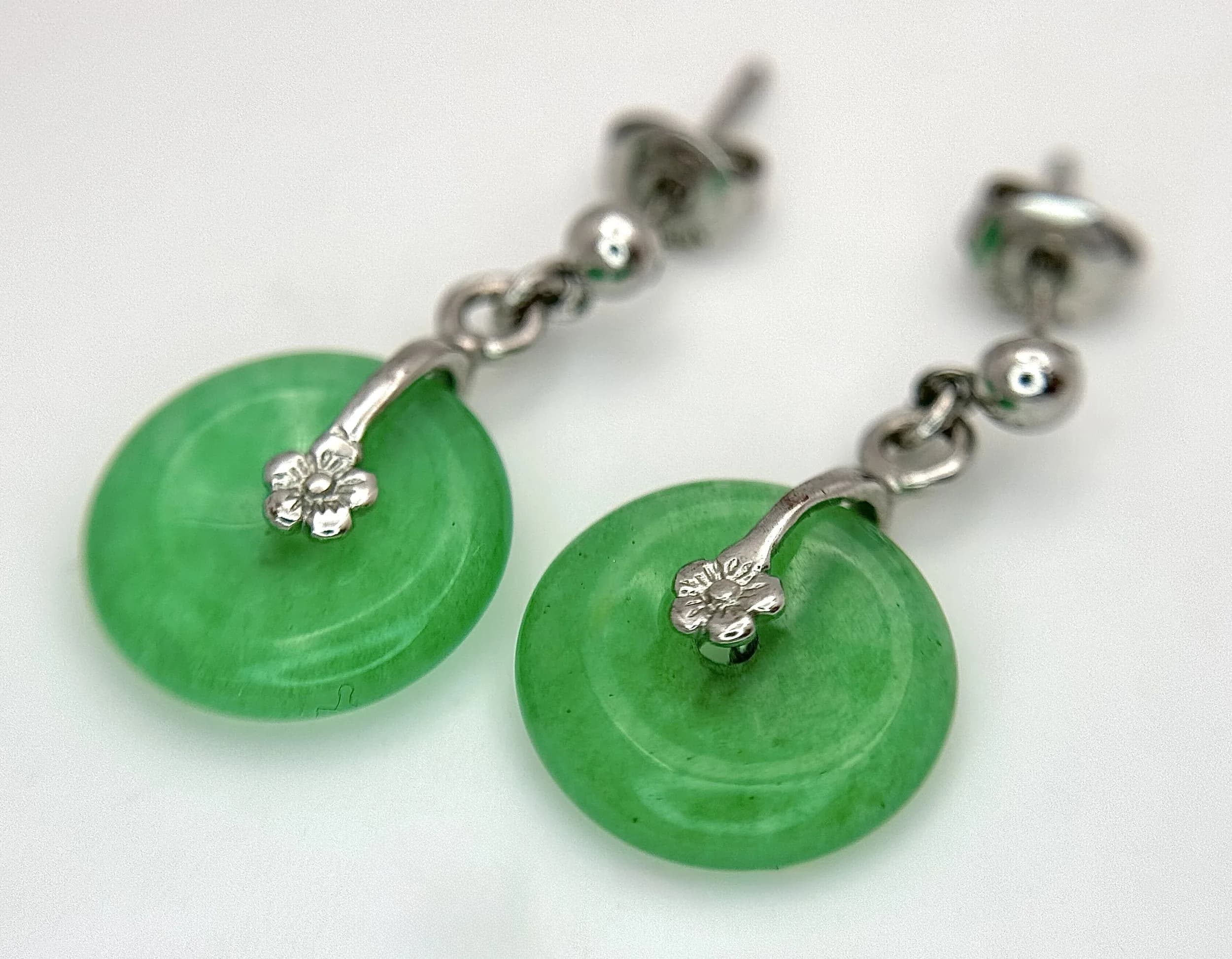 A Pretty Pair of 10k White Gold-Plated Jade Earrings. 1.2cm wide. Combined gross weight 2.11 grams.