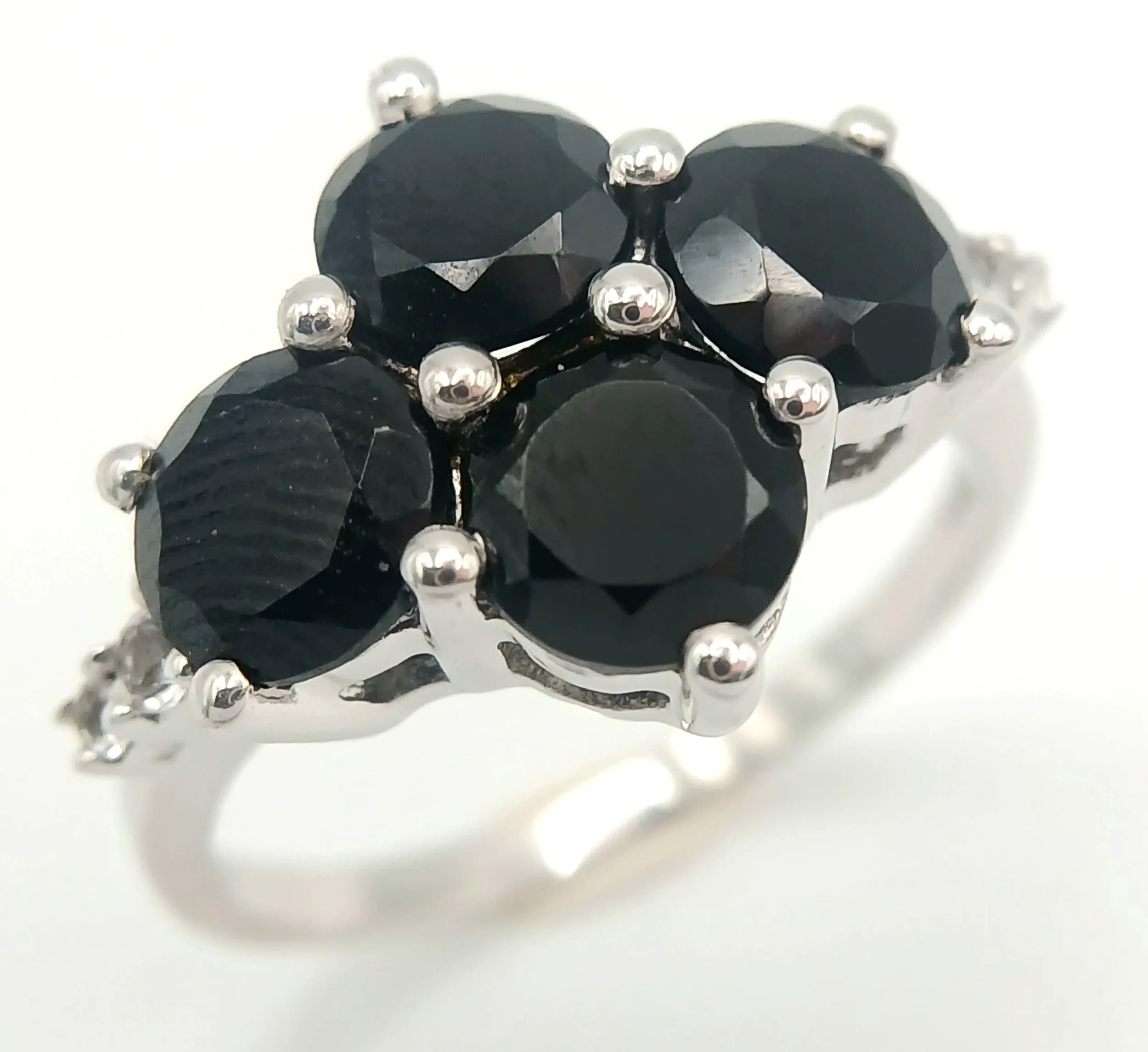A Stylish Sterling Silver Black Onyx and White Spinel Ring. Size P. The crown measures 1.4cm Wide and the Ring has a gross weight of 3.58 grams.