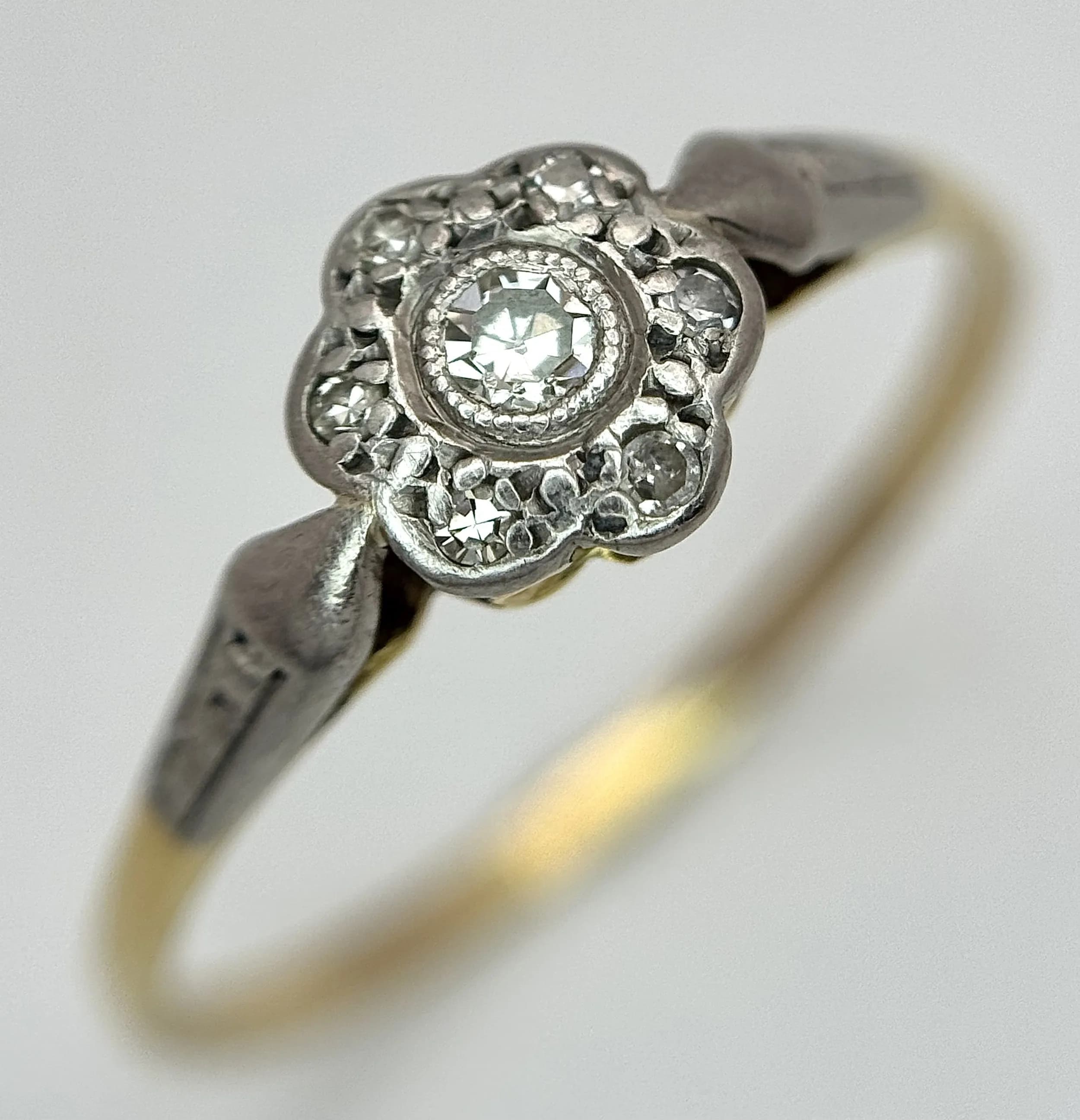 A 14K yellow gold diamond flower ring, 0.06ct diamond weight, 2g total weight, ring size U. Ref: SH9917H
