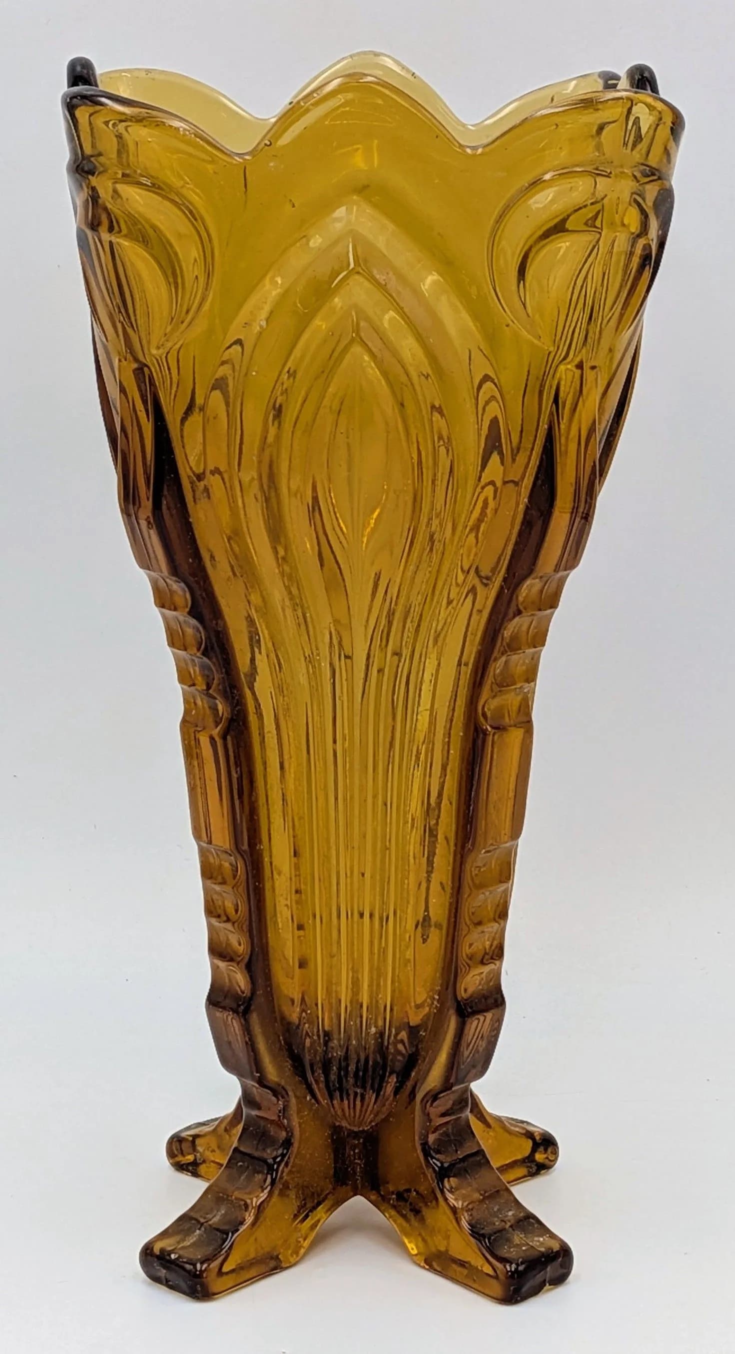 An art deco amber coloured glass vase, set on four feet, vase sits flat, height 26cm. See photos for condition.