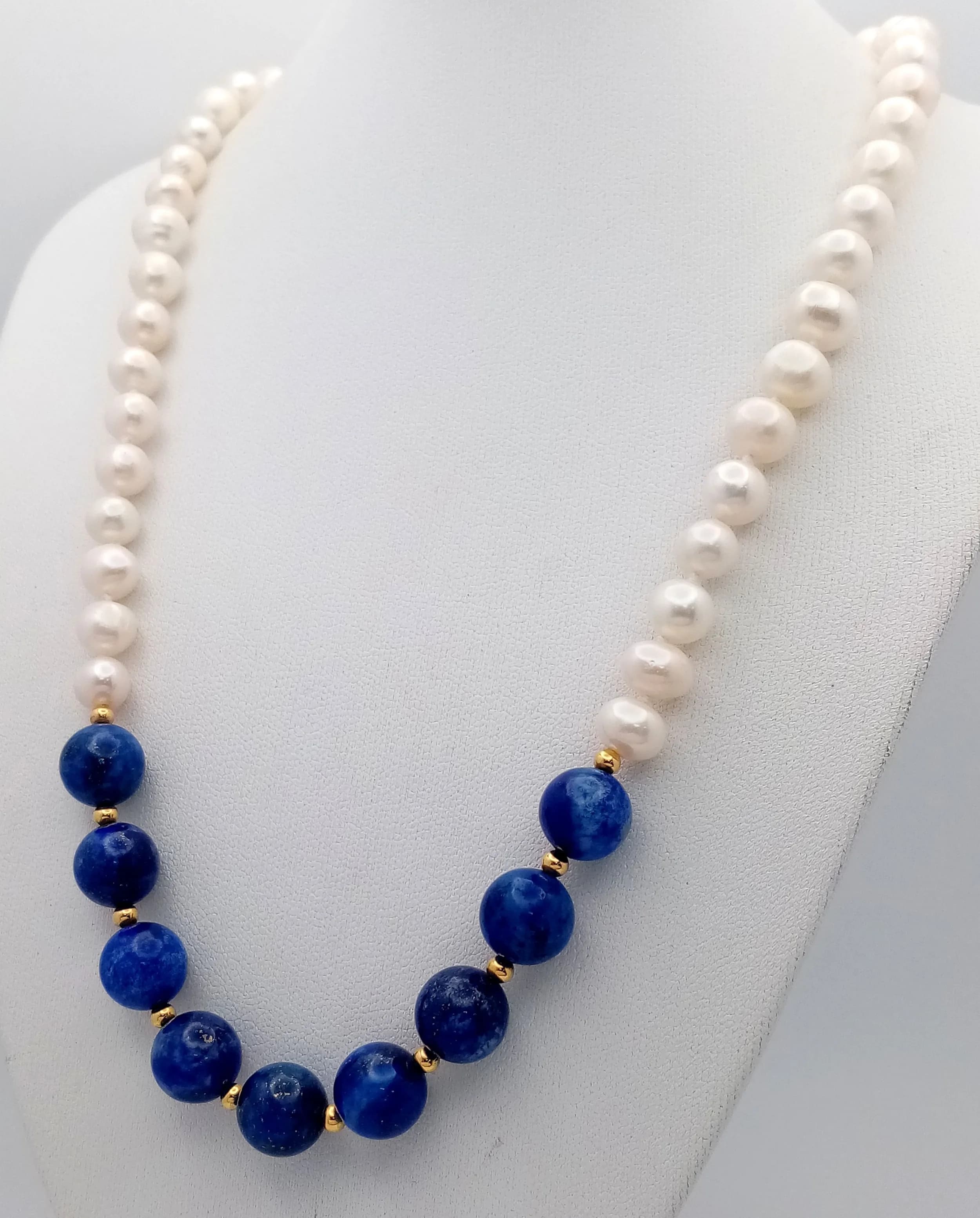 A Freshwater Pearl and Lapis Lazuli Necklace. 6mm pearls and 10mm Lapis. 44cm necklace length.
