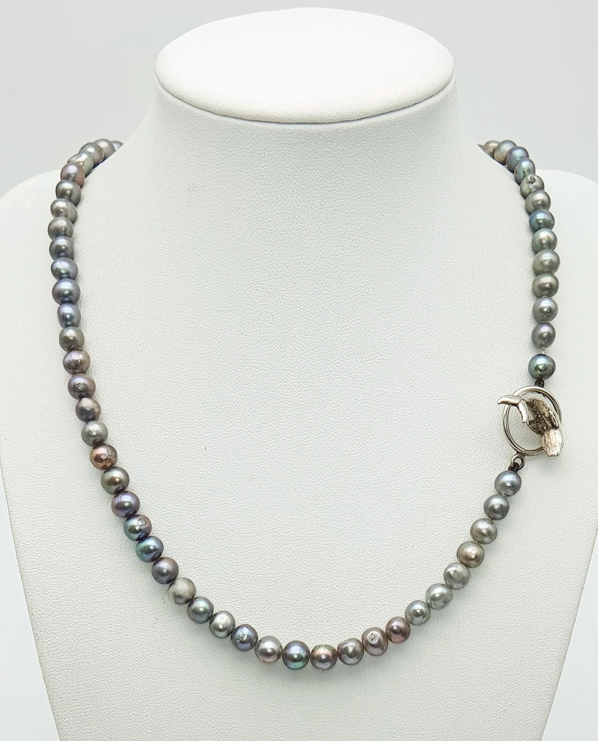 A Dolphin Design T-Bar Style Pearl Necklace. 50cm Length. Gross weight 31.9 grams.