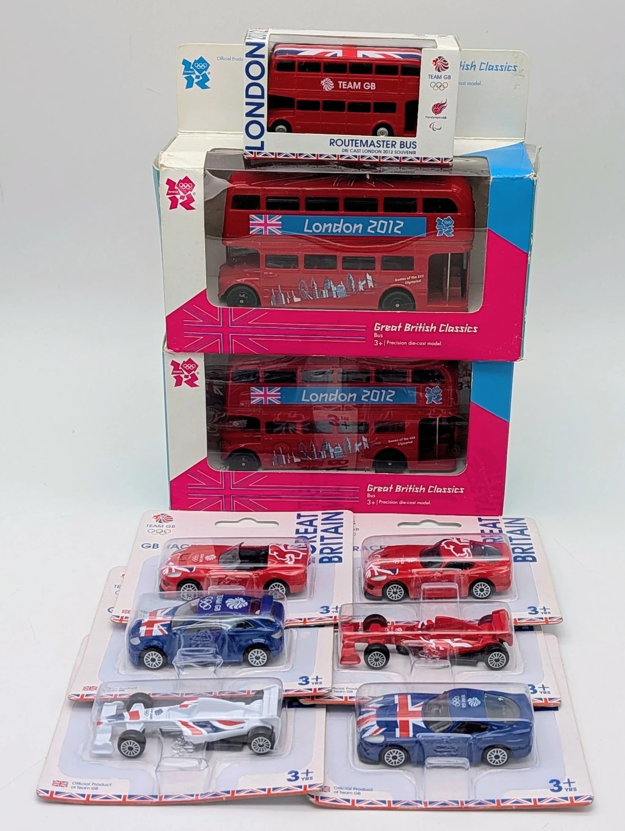 Nine 2012 Olympics souvenir die cast vehicles. All in original packaging. Good condition.