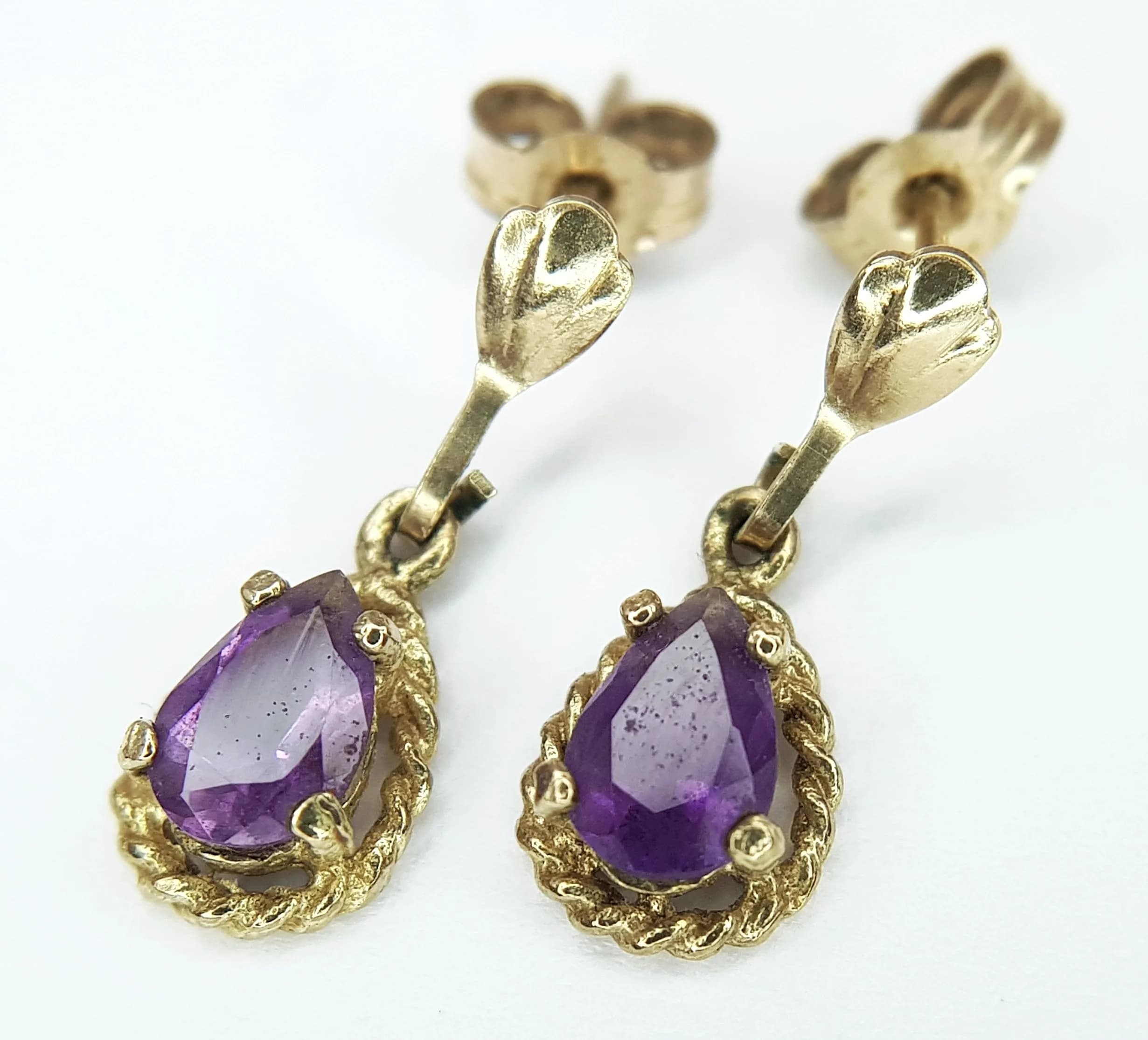 A Pair of 9K Yellow Gold and Amethyst Petit Drop Earrings. 1g total weight.