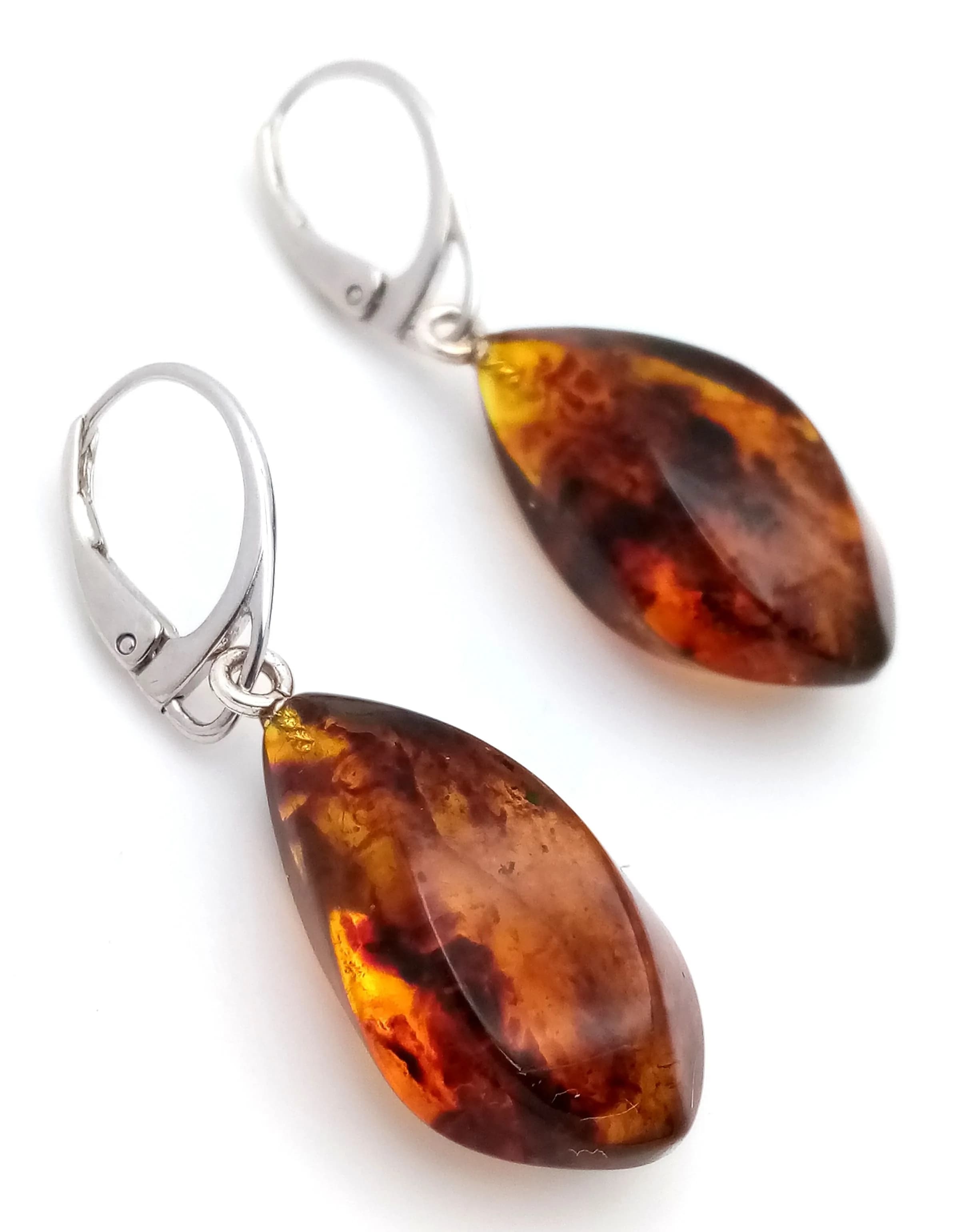 A Pair of Stylish 925 Silver Baltic Amber Effect Drop Earrings. Features faceted teardrop-shaped amber effect drops in rich cognac tones, suspended from silver hook fittings. Hallmarked 925. Made in Lithuania.