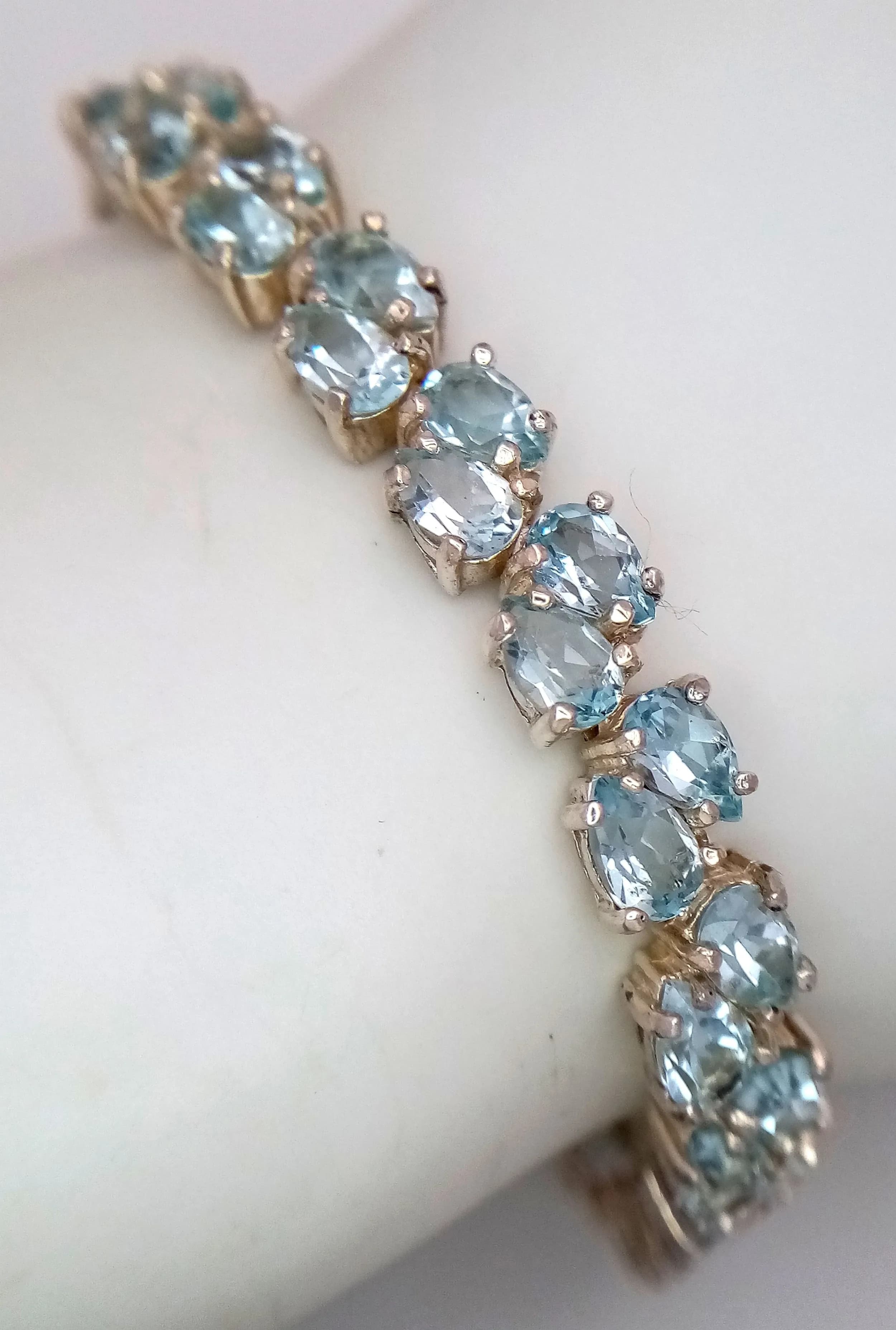A Beautiful Sterling Silver Two Row Blue Topaz Tennis Bracelet-19.5cm Length. 7mm Width. Set with Fifty 6 x 4mm Pear Cut Blue Topaz, approximately 25 carat total. Gross weight 21.9 grams.