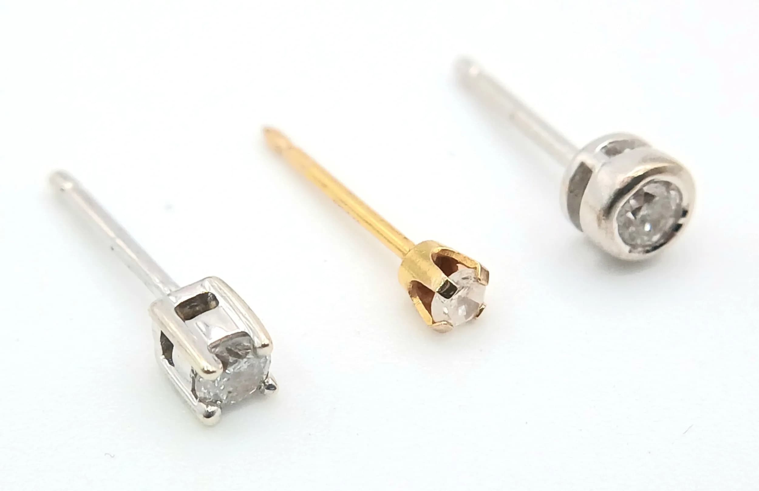 Three Gold and Diamond Stud Earrings. Small diamonds. No backs. 0.6g total weight.