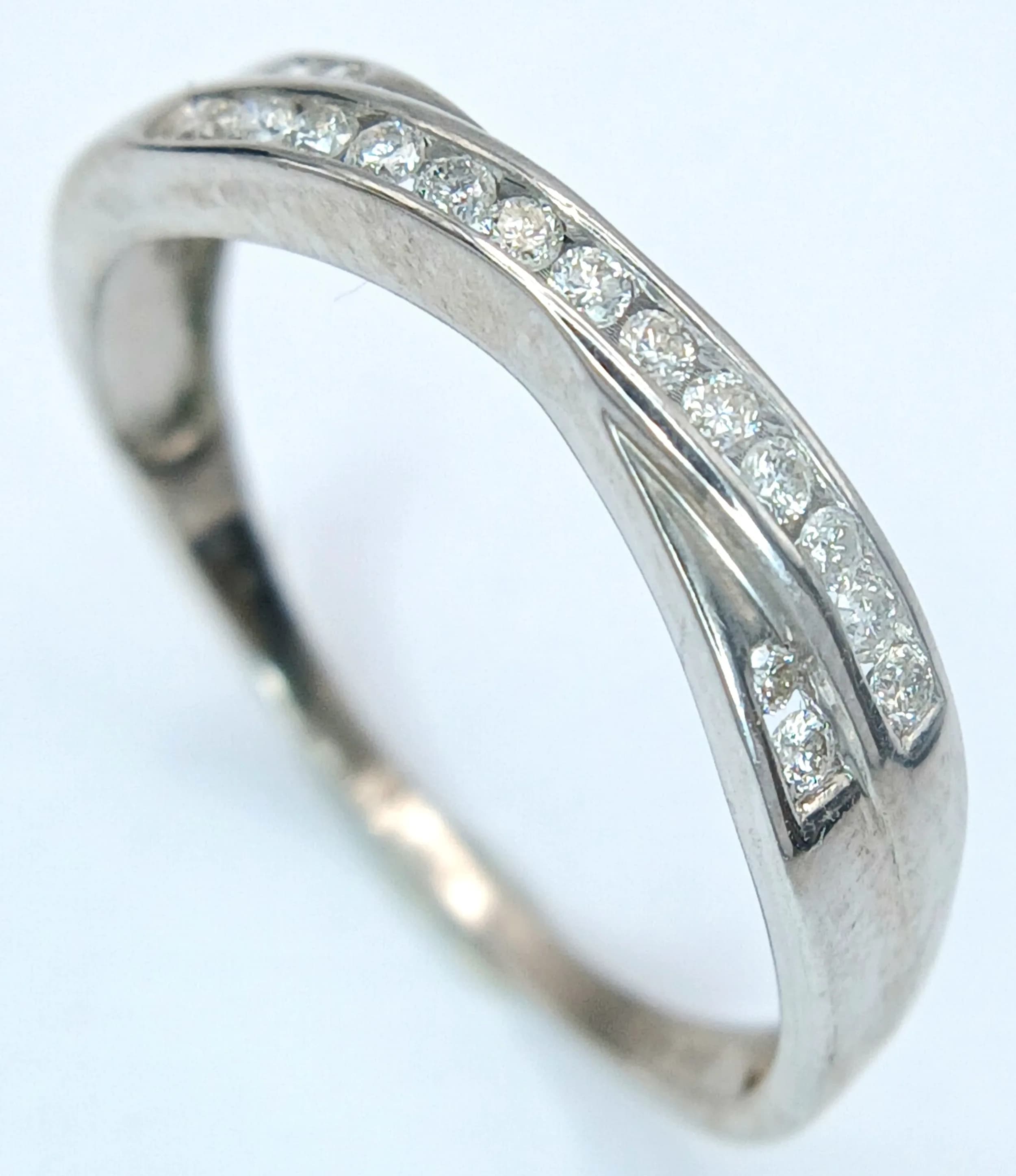 A 9K white gold diamond crossover ring, 0.17ct diamond weight, 2.2g total weight, ring size T. Ref: SH9546H
