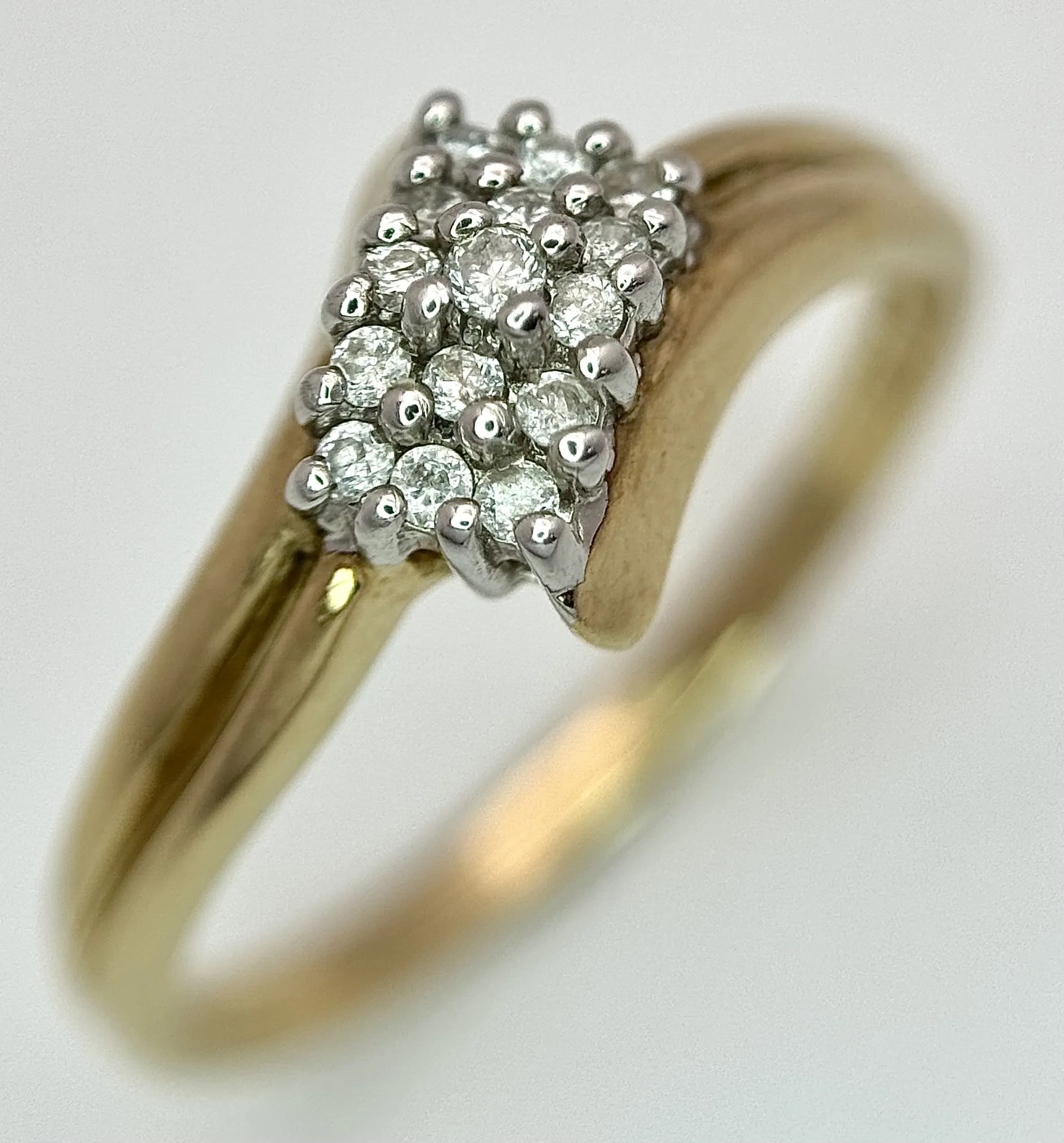 A 9K yellow gold diamond cluster ring, 0.08ct diamond weight, 2.1g total weight, ring size P. Ref: SH9869H