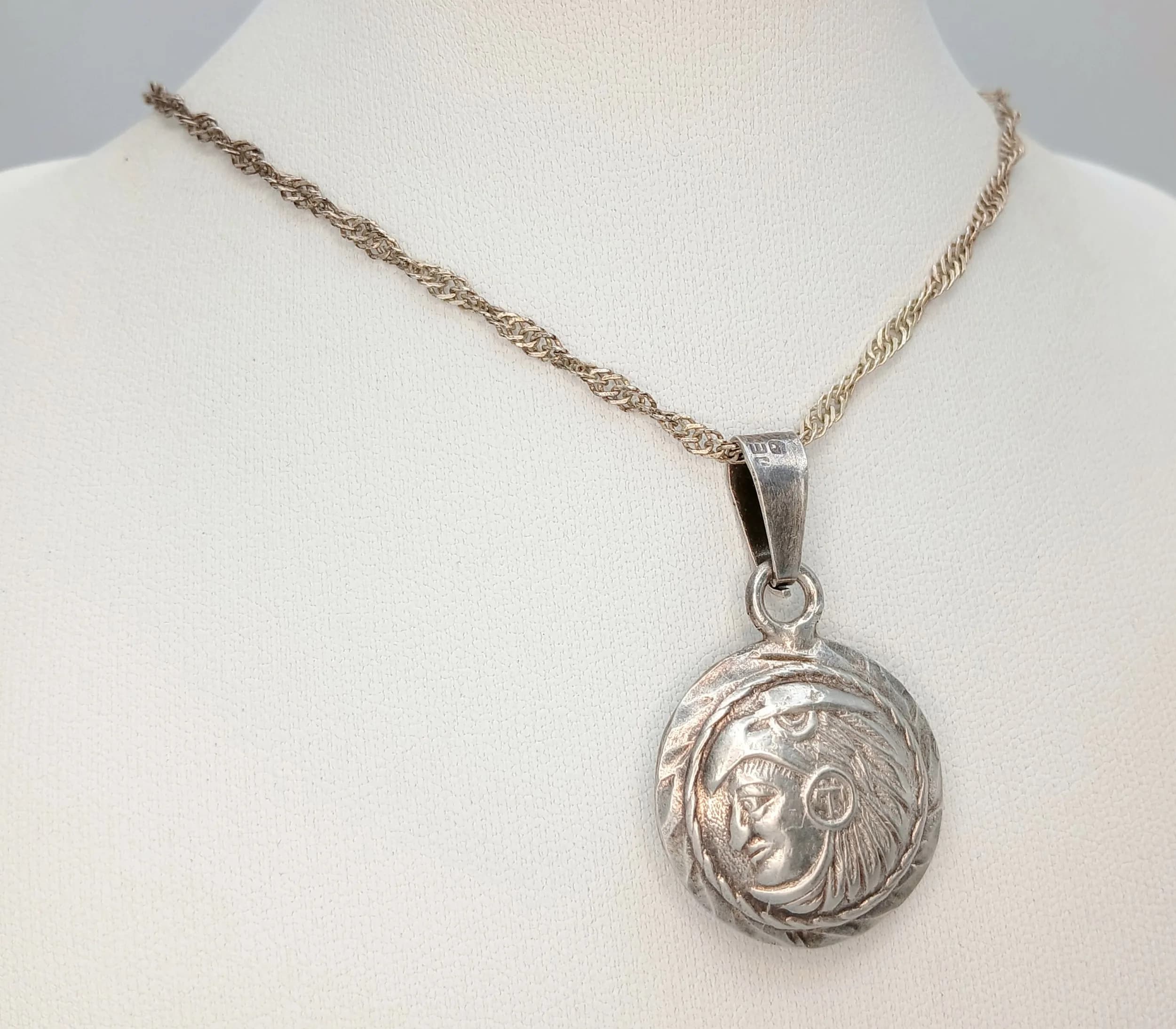 A Mexican 925 Silver Reversible Mayan Calendar Pendant Necklace. The pendant features a Mayan calendar design to one side and warrior god detail to the reverse. 46cm length necklace. 12.44g total weight.