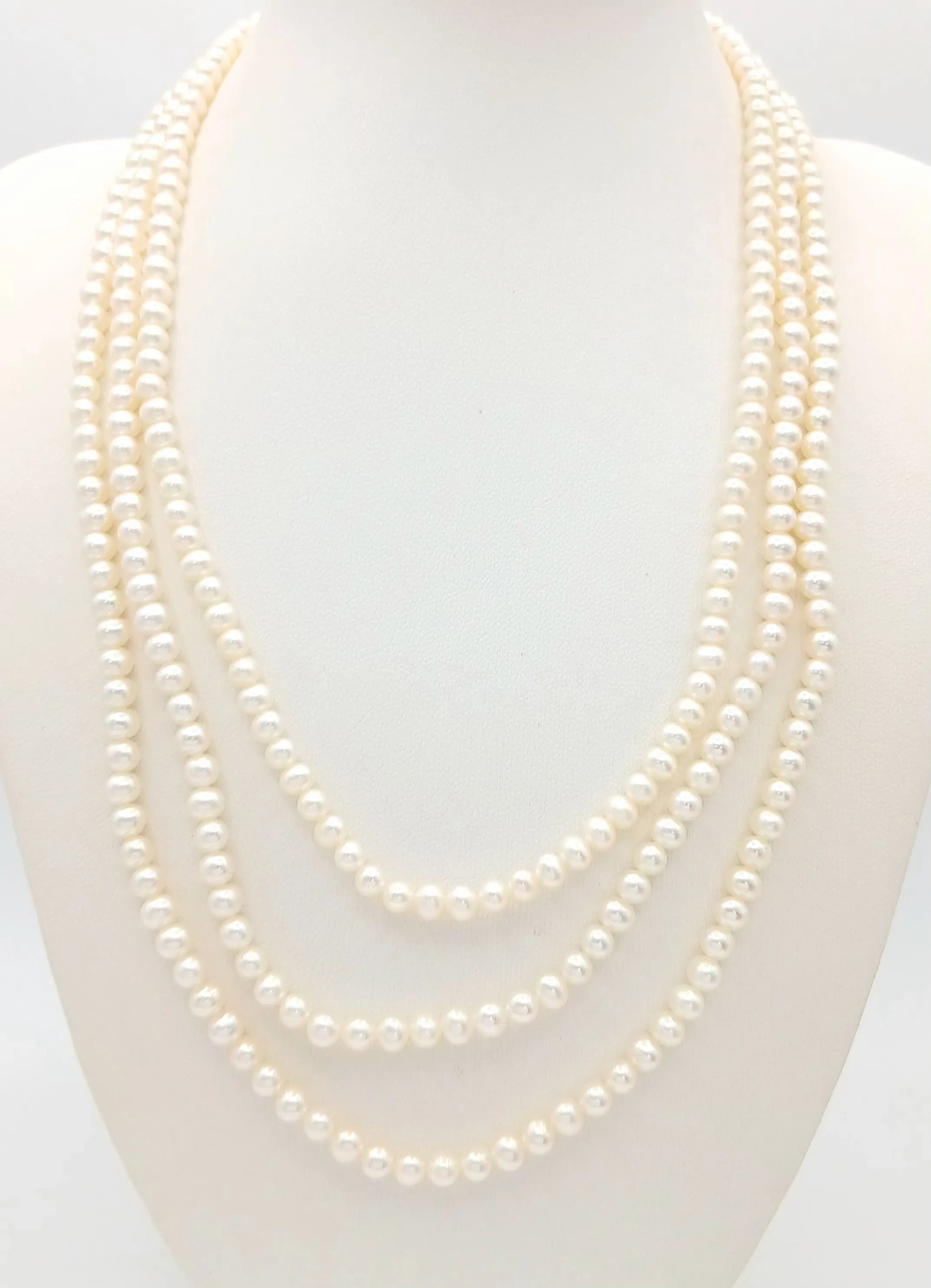 An elegant Three-Strand Freshwater Pearl Necklace. Comprising three strands of white freshwater pearls with box clasp. Approx 45.5cm in length. Please see photos for details.