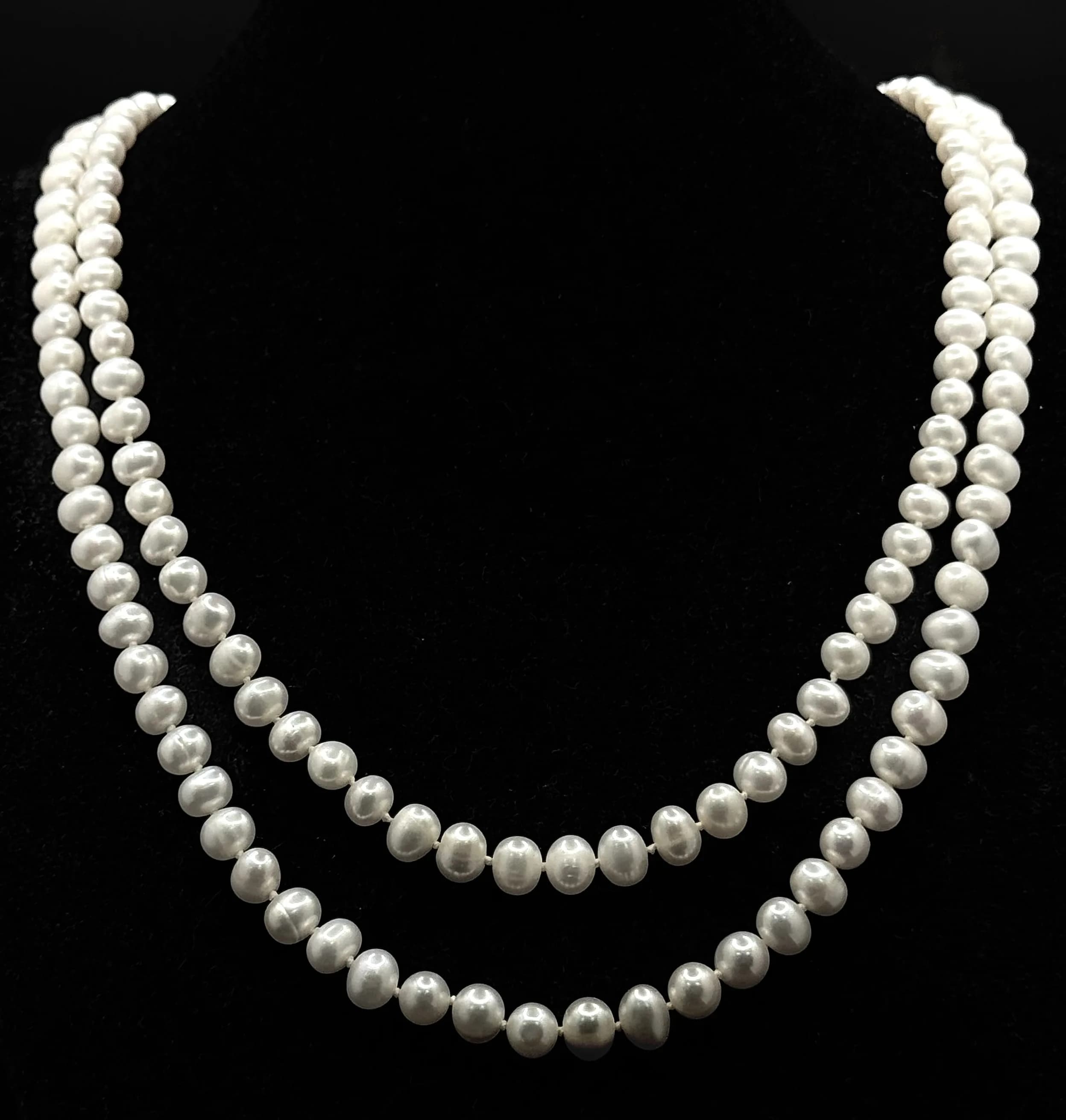 A gorgeous matinee length creamy white Freshwater Pearls link necklace. Total length 124cm. Individual knotted Pearls-6mm approx.