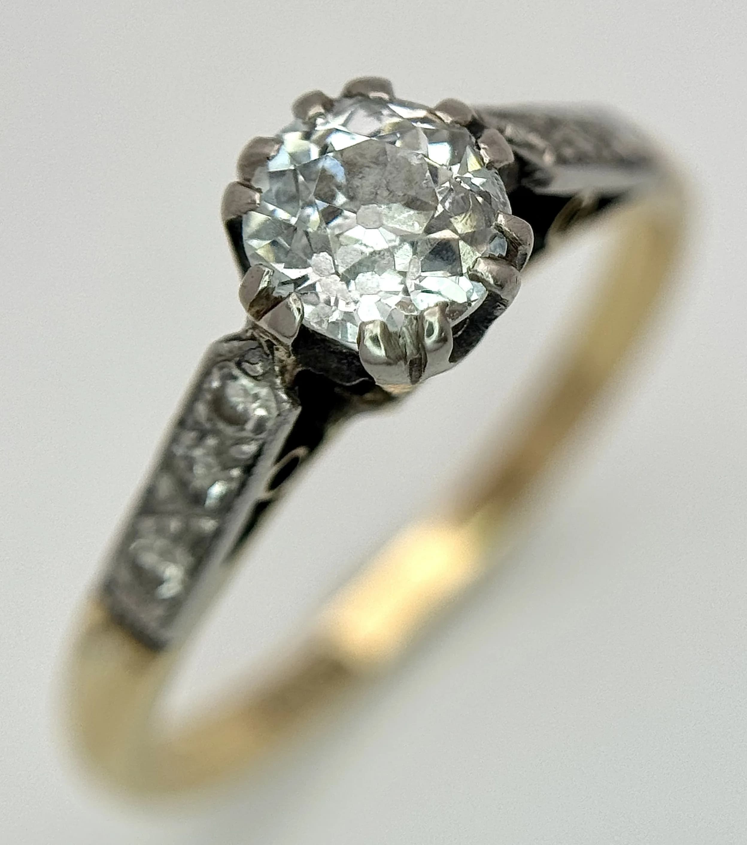 An 18K Yellow Gold Old Cut Diamond Ring. 0.6ct centre stone with three small diamonds to shoulders. Size M. 2.44g total weight. Ref: 27132003