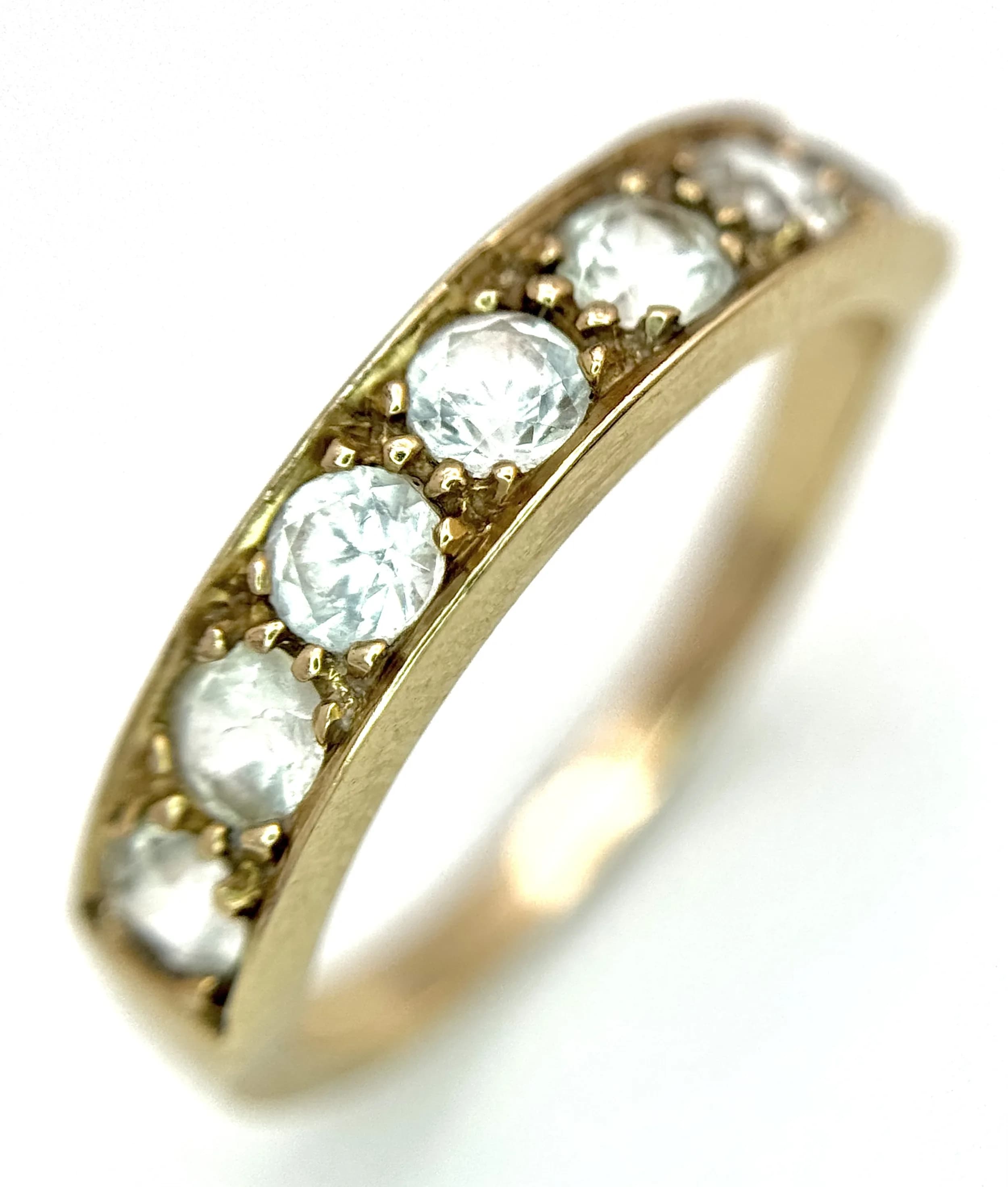 A 14K Yellow Gold (tests as) White Stone Half Eternity Ring. Size L 1/2. 2.7g total weight.
