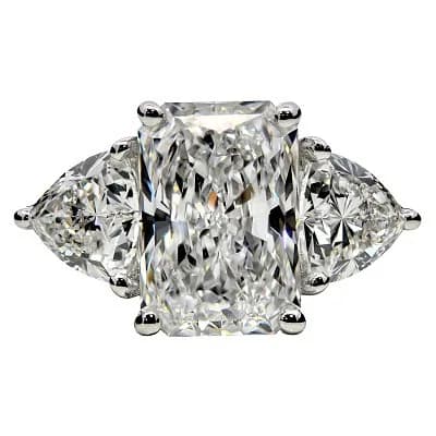 A PLATINUM RADIANT AND TRILLION CUT LAB GROWN DIAMOND 3 STONE RING. CENTRAL STONE 3.05ct, SIDE STONES 1.46CTW. COLOUR D, CLARITY VS2. IGI CERTIFIED. CERT NO- LG7786755842. TOTAL DIAMOND WEIGHT: 4.51CTW. TOTAL WEIGHT 7.34gms. SIZE L. Ref U4539