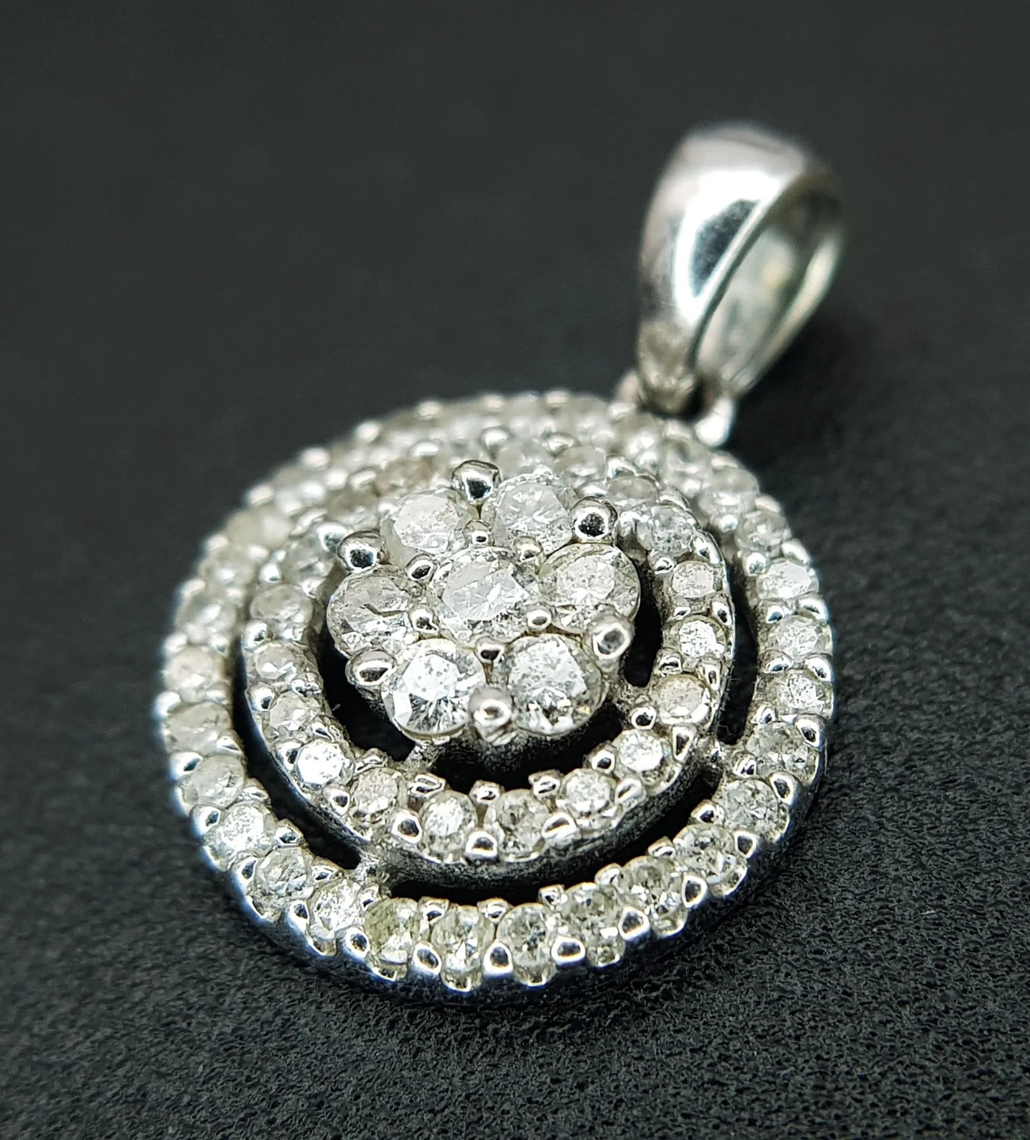 A 14K WHITE GOLD, DIAMOND SET, CIRCULAR PENDANT. 0.30CTW. 1.1G. J P 6003