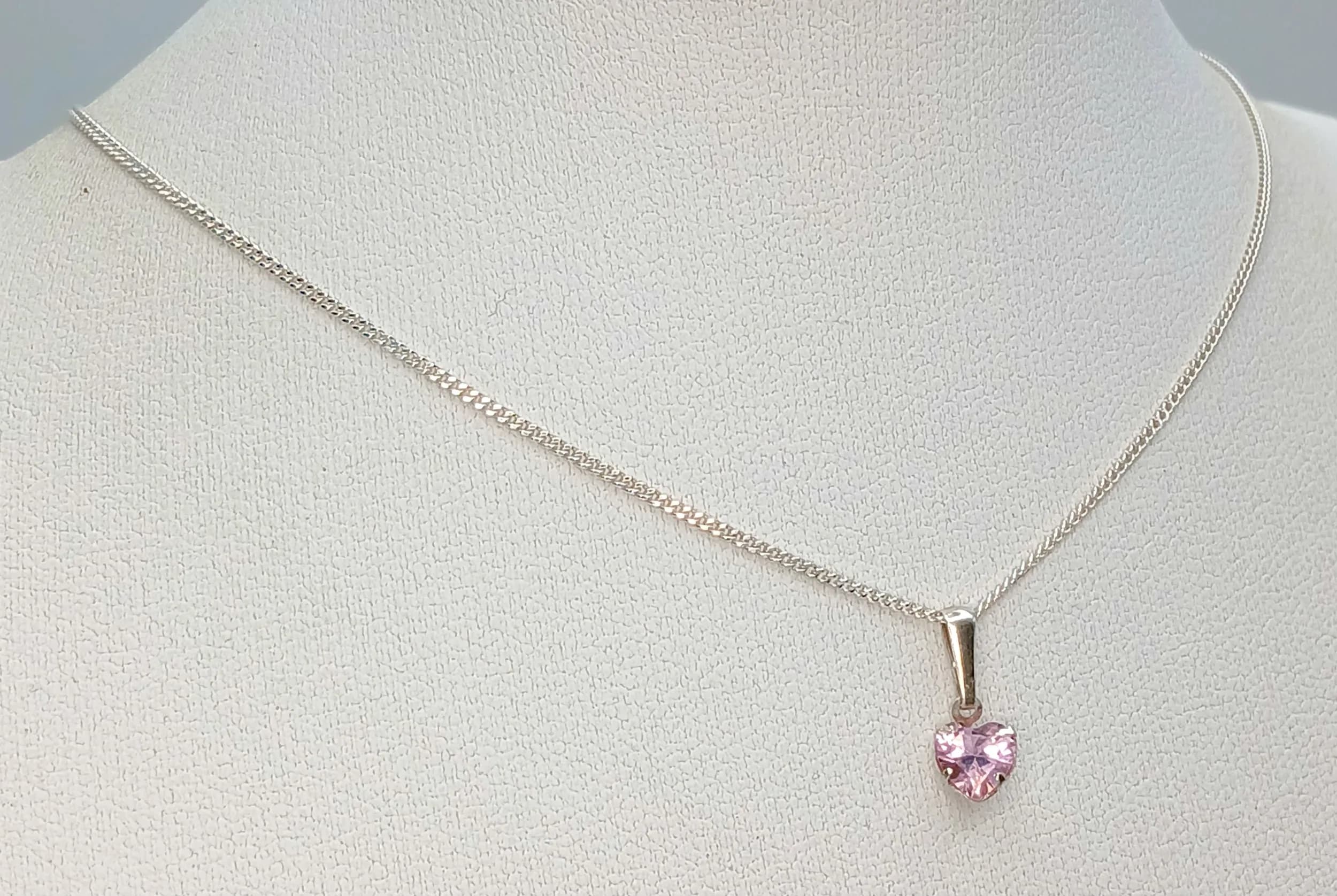 A Stunning 925 Sterling Silver Pink CZ Heart Pendant Necklace - 36cm Length. Features a heart-shaped pink CZ pendant on a fine sterling silver chain. The pendant measures 1cm x 1cm. Gross weight 1.40 grams.