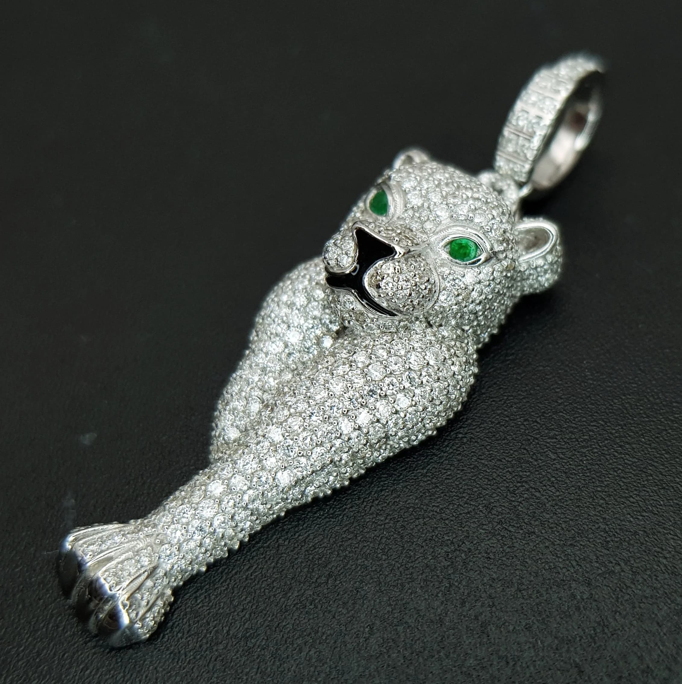 An 18K White Gold and Diamond Panther Pendant. Diamond encrusted with emerald eyes! 1.75ctw of pave set diamonds having G colour and VS2 clarity. 5cm. 7.85g total weight. Ref: 71600.