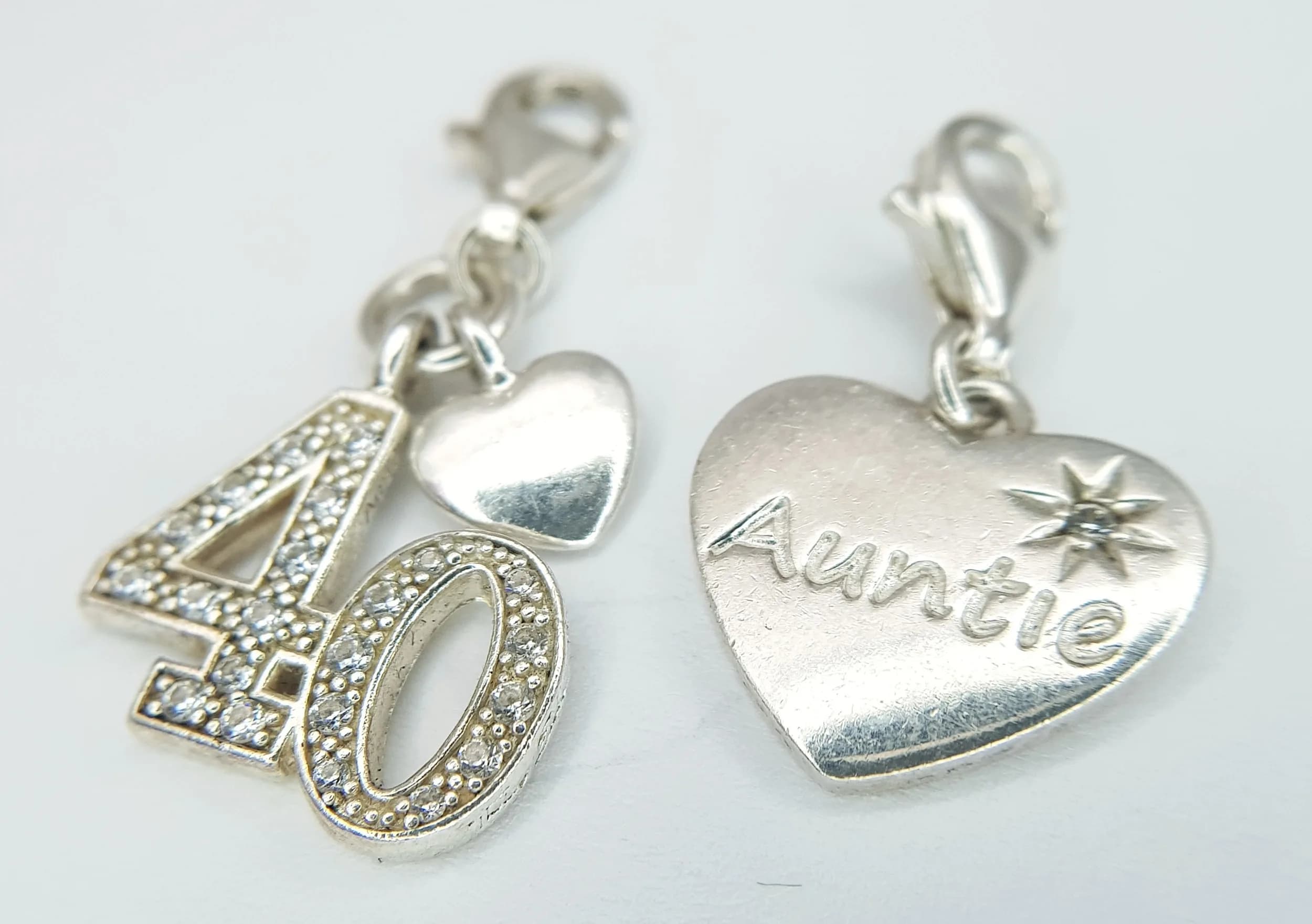 A PAIR OF THOMAS SABO, STERLING SILVER, STONE SET CHARMS. 40 AND AUNTIE. 4.6G. TREV SIL 6003