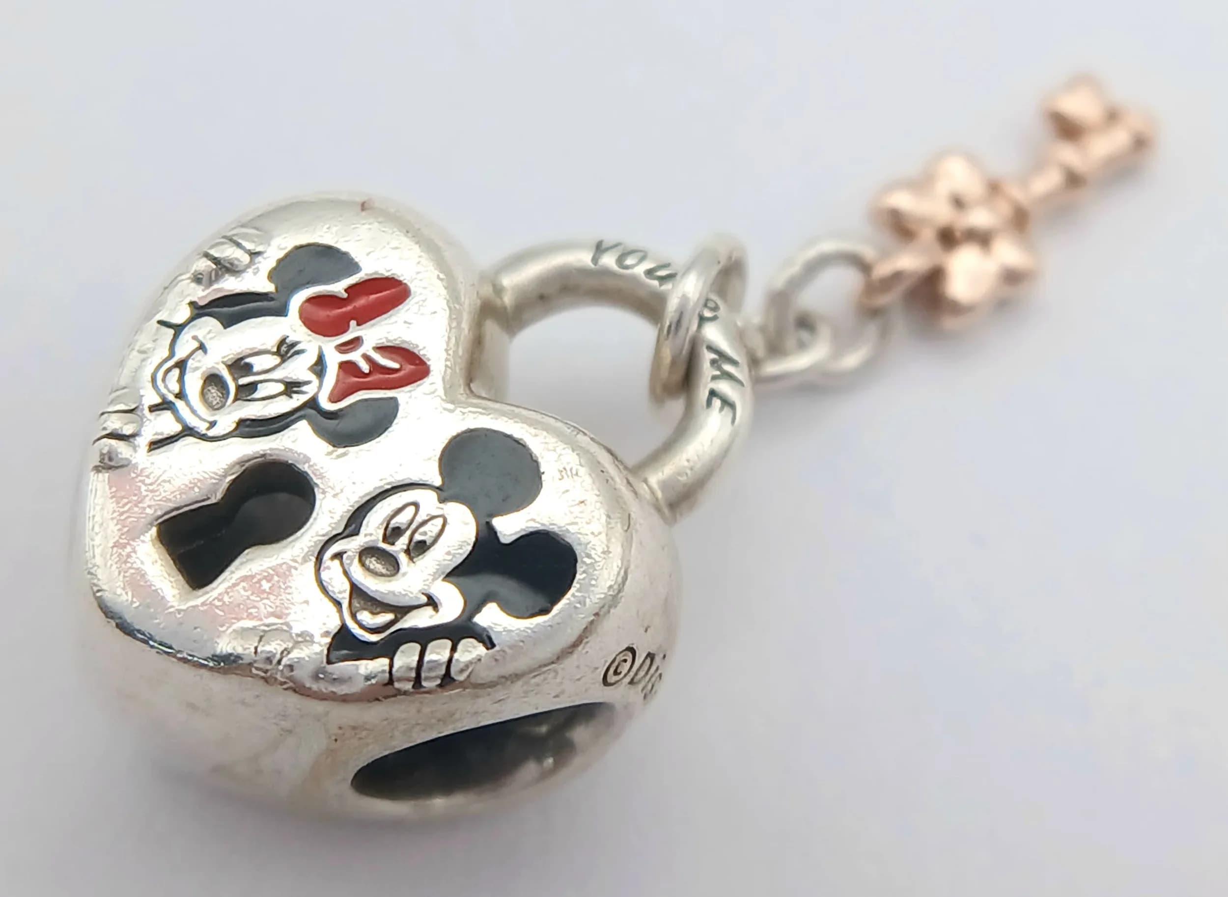 A PANDORA, STERLING SILVER AND 14K ROSE GOLD, DISNEY, MICKEY AND MINNIE MOUSE, PADLOCK HEART DANGLE KEY CHARM. 4.6G. TREV SIL 6011