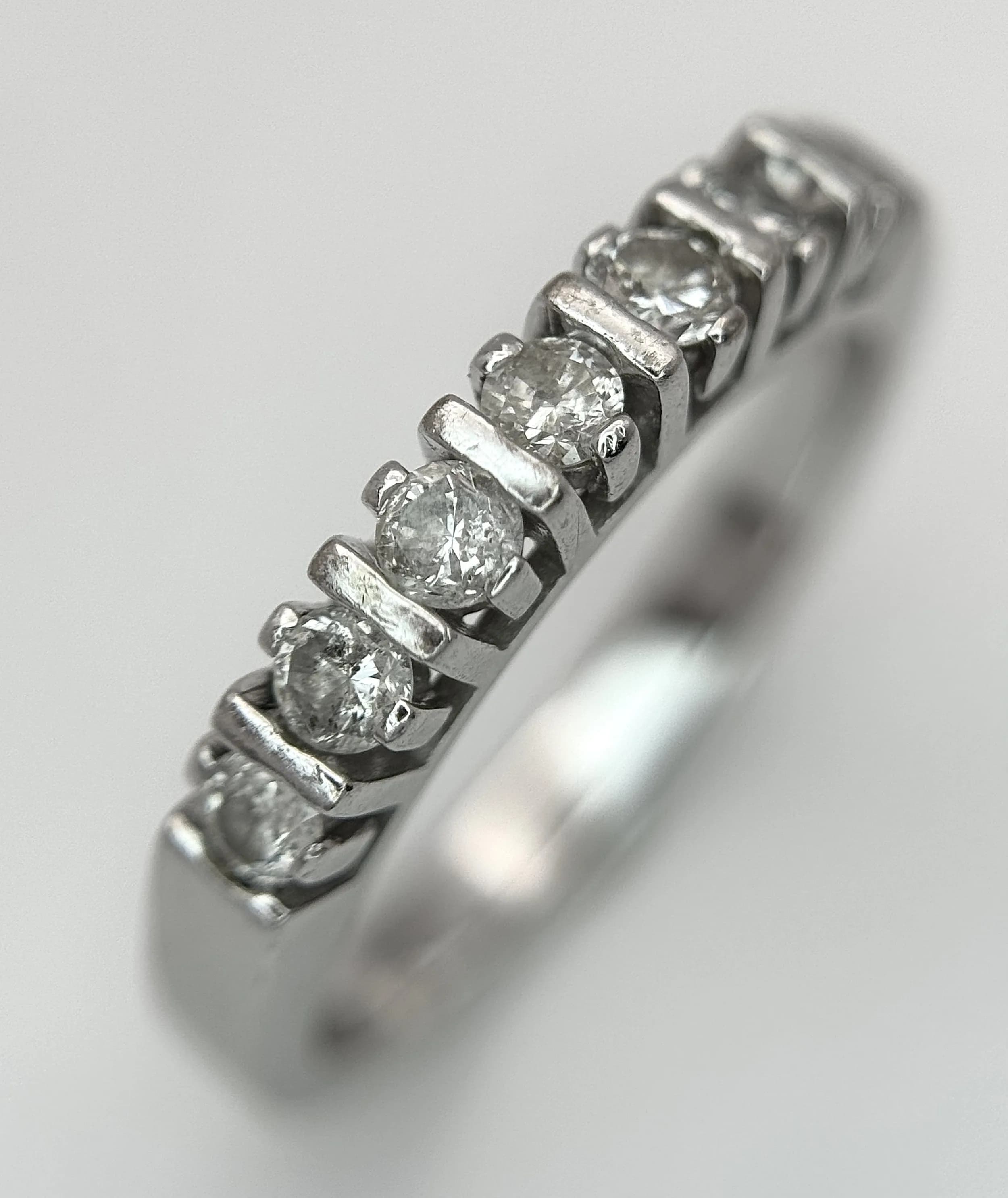 An 18K White Gold Seven Stone Diamond Ring. Ring size L - M. 3.93g total weight. Ref: 7/72306