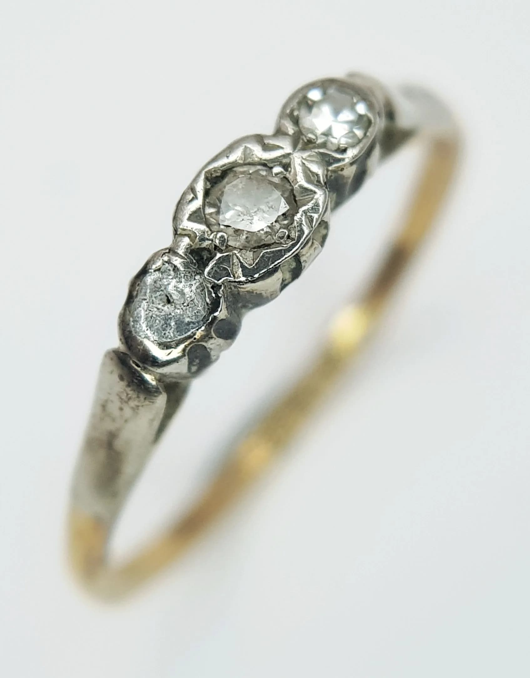 An Antique 18K Yellow Gold and Platinum Three Stone Diamond Ring. Size L 1/2. 1.9g total weight.