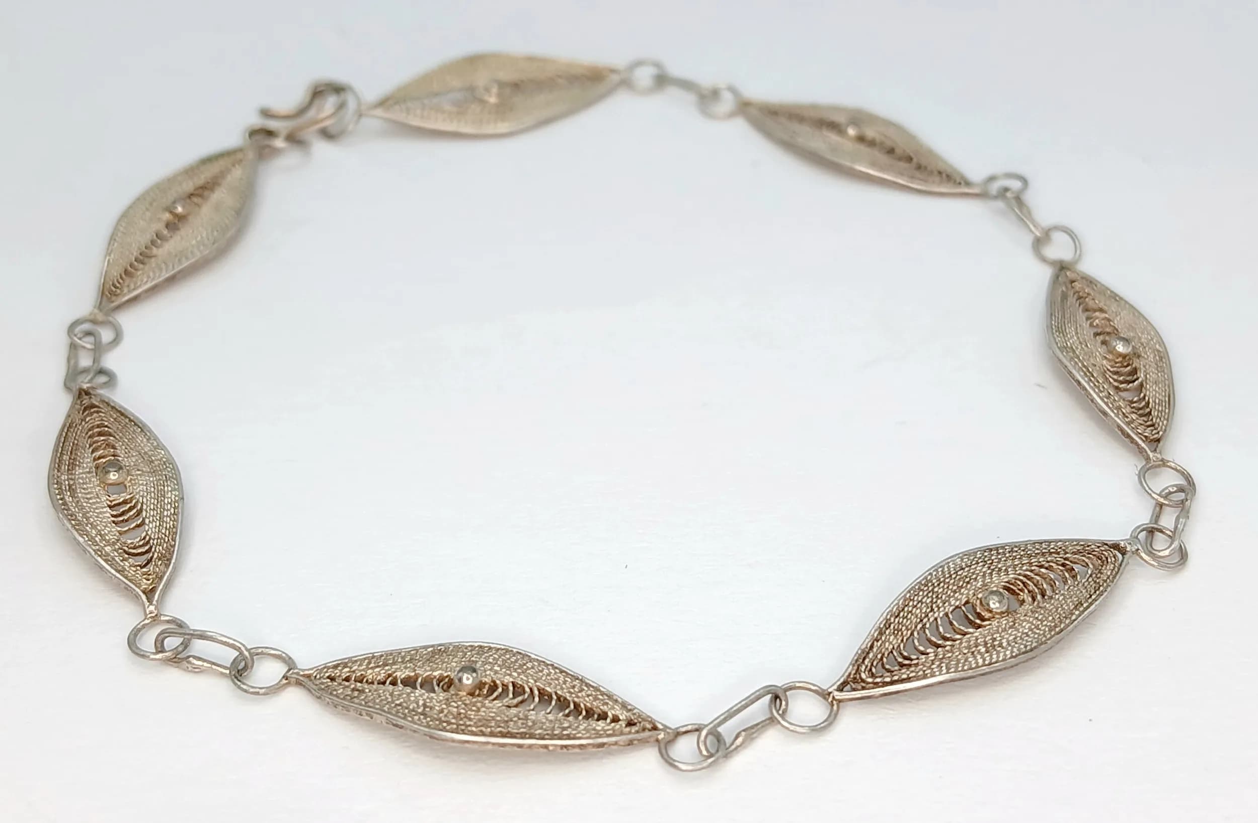 A Vintage Silver Filigree Panel Bracelet - 19cm Length. Features six marquise-shaped filigree panels joined by fine link connections. Gross weight 2.49 grams.