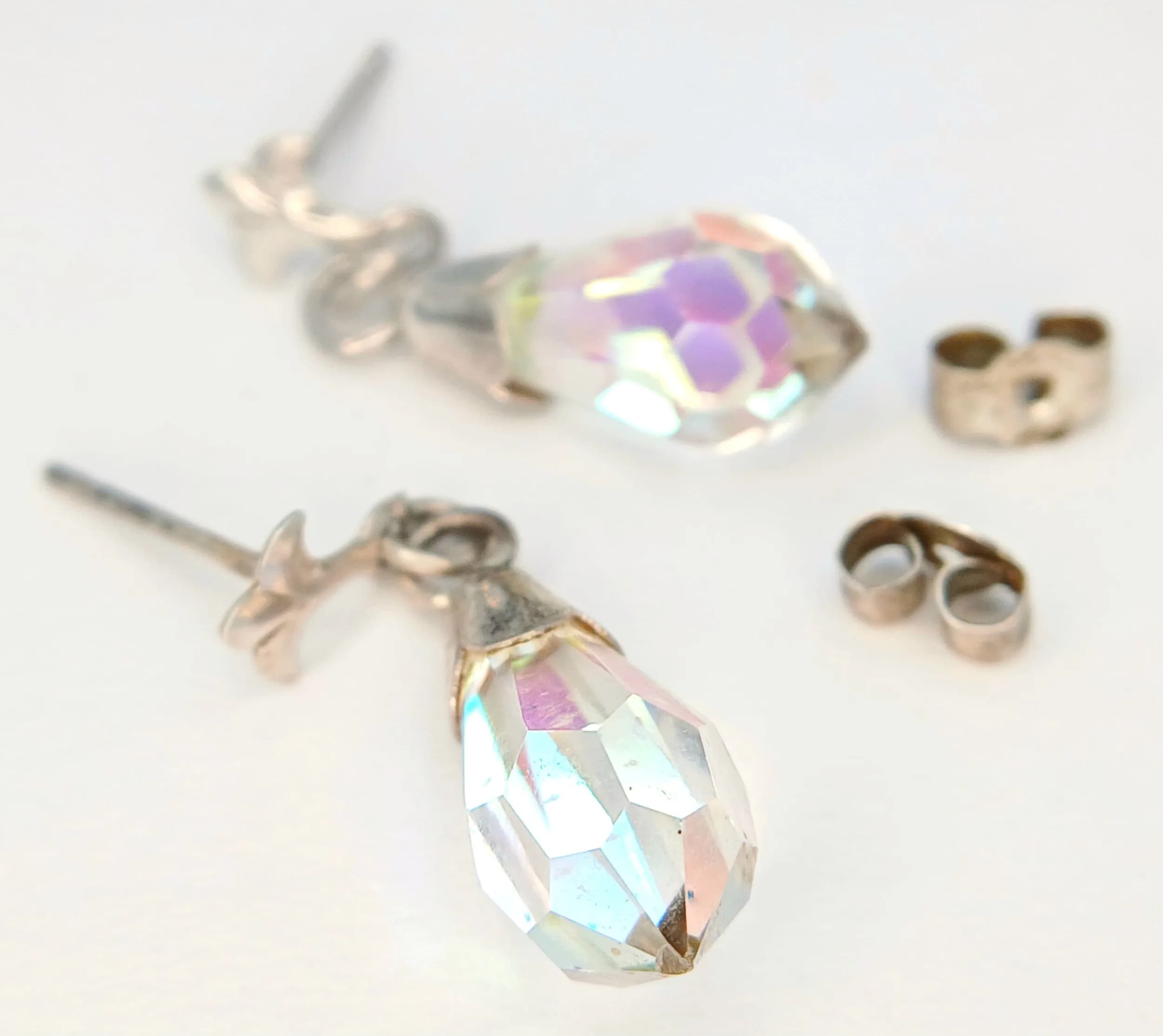 An Attractive Pair of 925 Sterling Silver Aurora Borealis Crystal Drop Earrings. Features faceted Aurora Borealis crystal drops with stud fittings and butterfly backs. The earrings measure approx 2cm drop. Gross weight 1.70 grams. Comes with a presentation case.